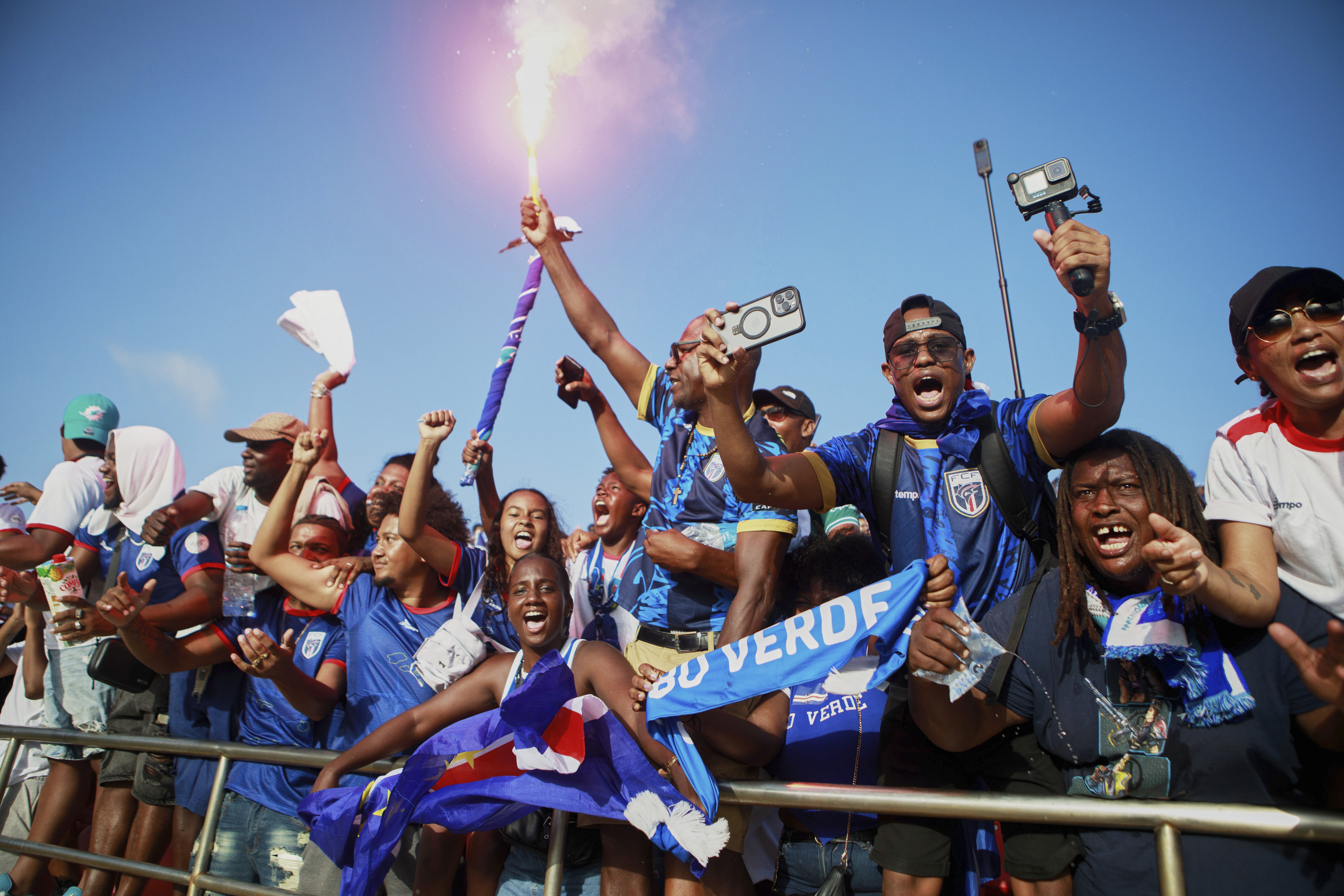 Fans celebrate in the stands after Cape Verde defeated Eswatini in a World Cup qualifying soccer match at Estádio Nacional in Praia, Cape Verde, Monday, Oct. 13, 2025, to clinch their qualification for the 2026 World Cup. (AP Photo/Cristiano Barbosa)