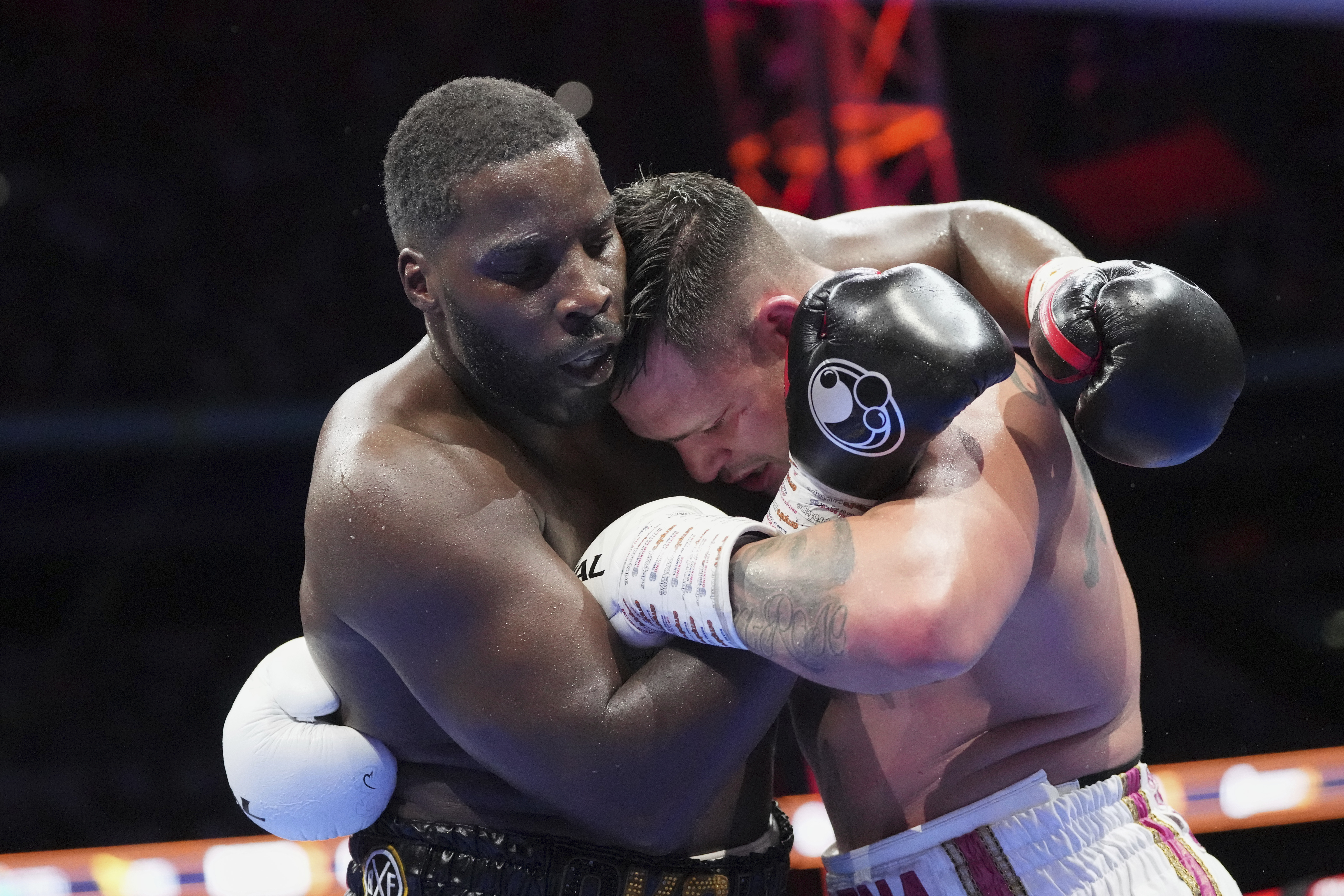 Britain's Lawrence Okolie, left, and South Africa's Kevin Lerena in action during the world heavyweight boxing title fight In London, Saturday, July 19, 2025. (AP Photo/Frank Augstein)