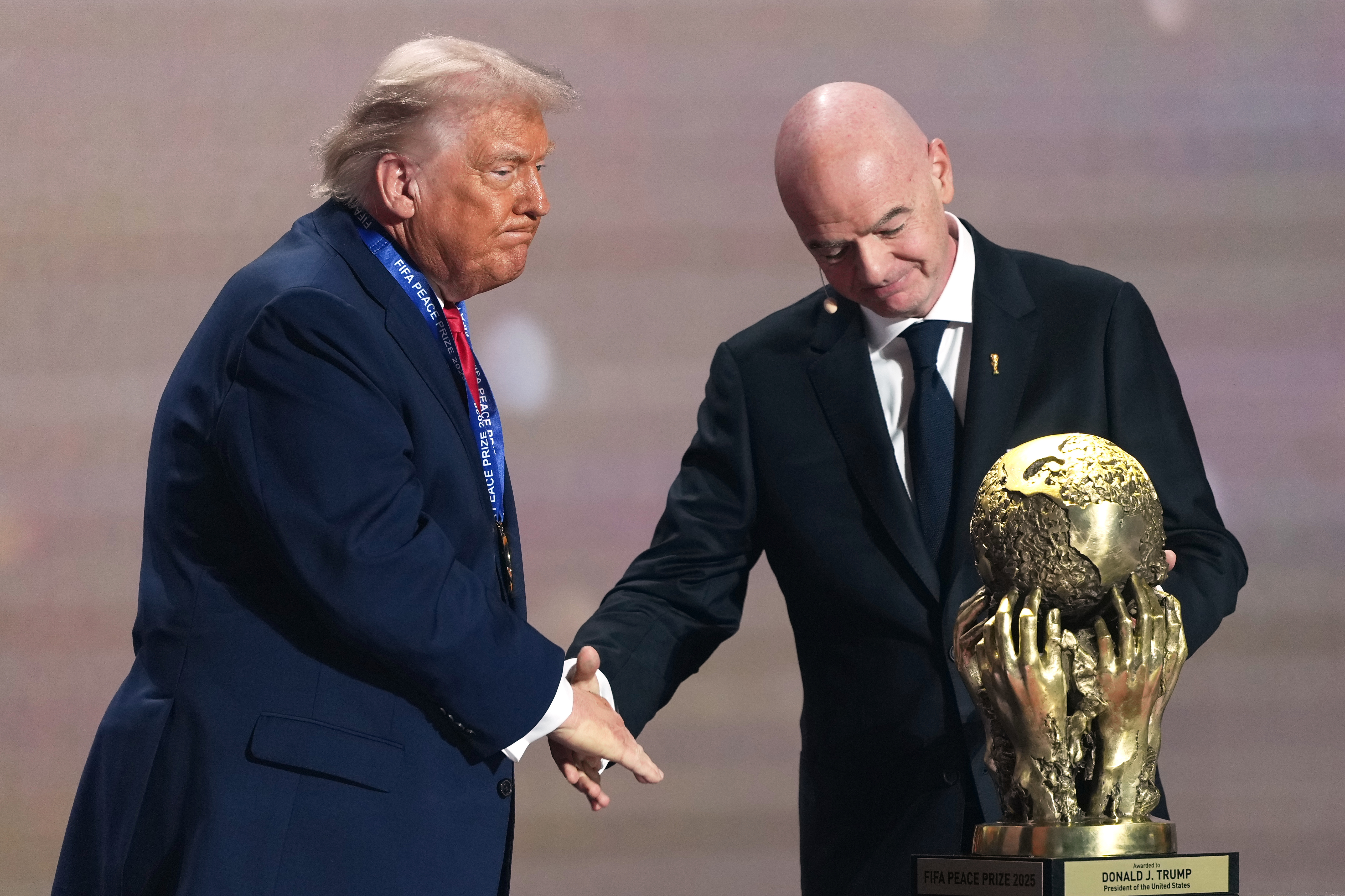 FILE - FIFA President Gianni Infantino presents President Donald Trump with the FIFA Peace Prize during the draw for the 2026 soccer World Cup at the Kennedy Center in Washington, Friday, Dec. 5, 2025. (AP Photo/Stephanie Scarbrough, Pool, File_