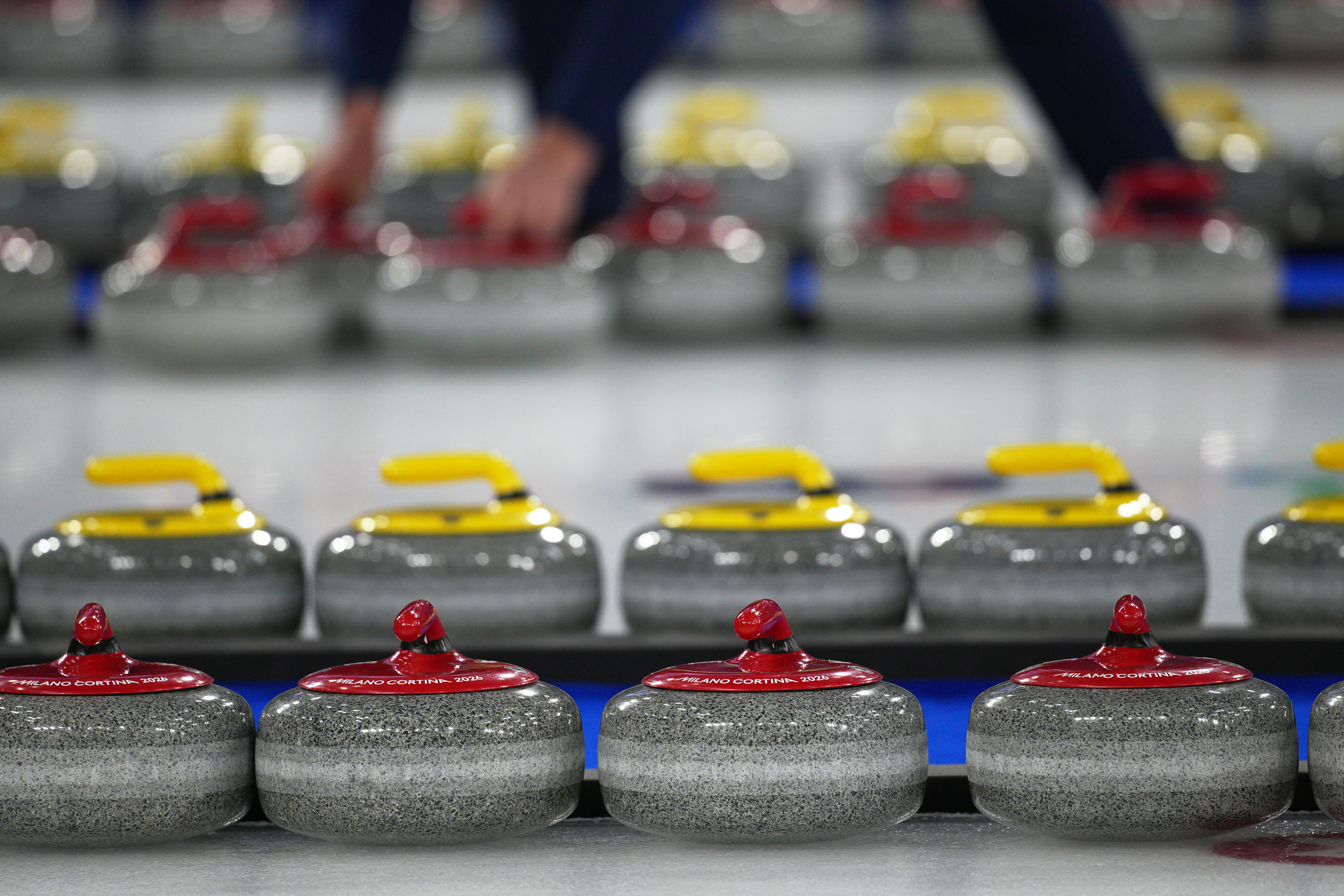 Curling stones are arranged during a wheelchair curling mixed doubles round robin session at the 2026 Winter Paralympics, in Cortina d'Ampezzo, Italy, Thursday, March 5, 2026. (AP Photo/Emilio Morenatti)