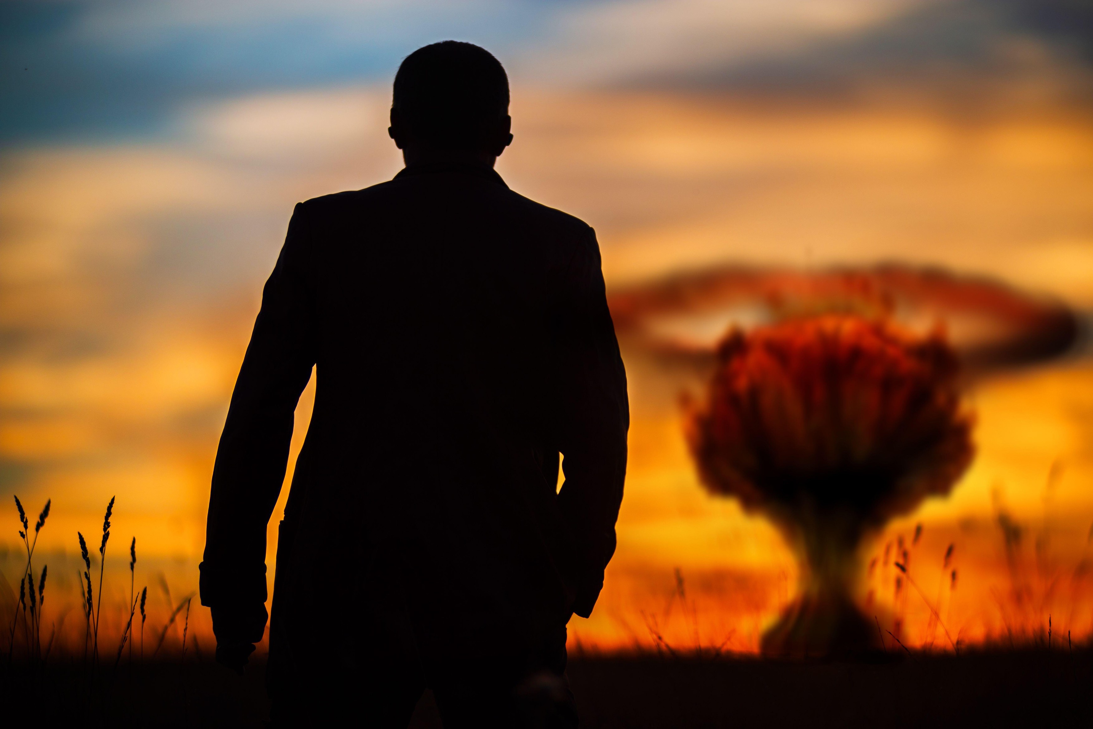 The concept of a nuclear strike. Silhouette of a man in a suit