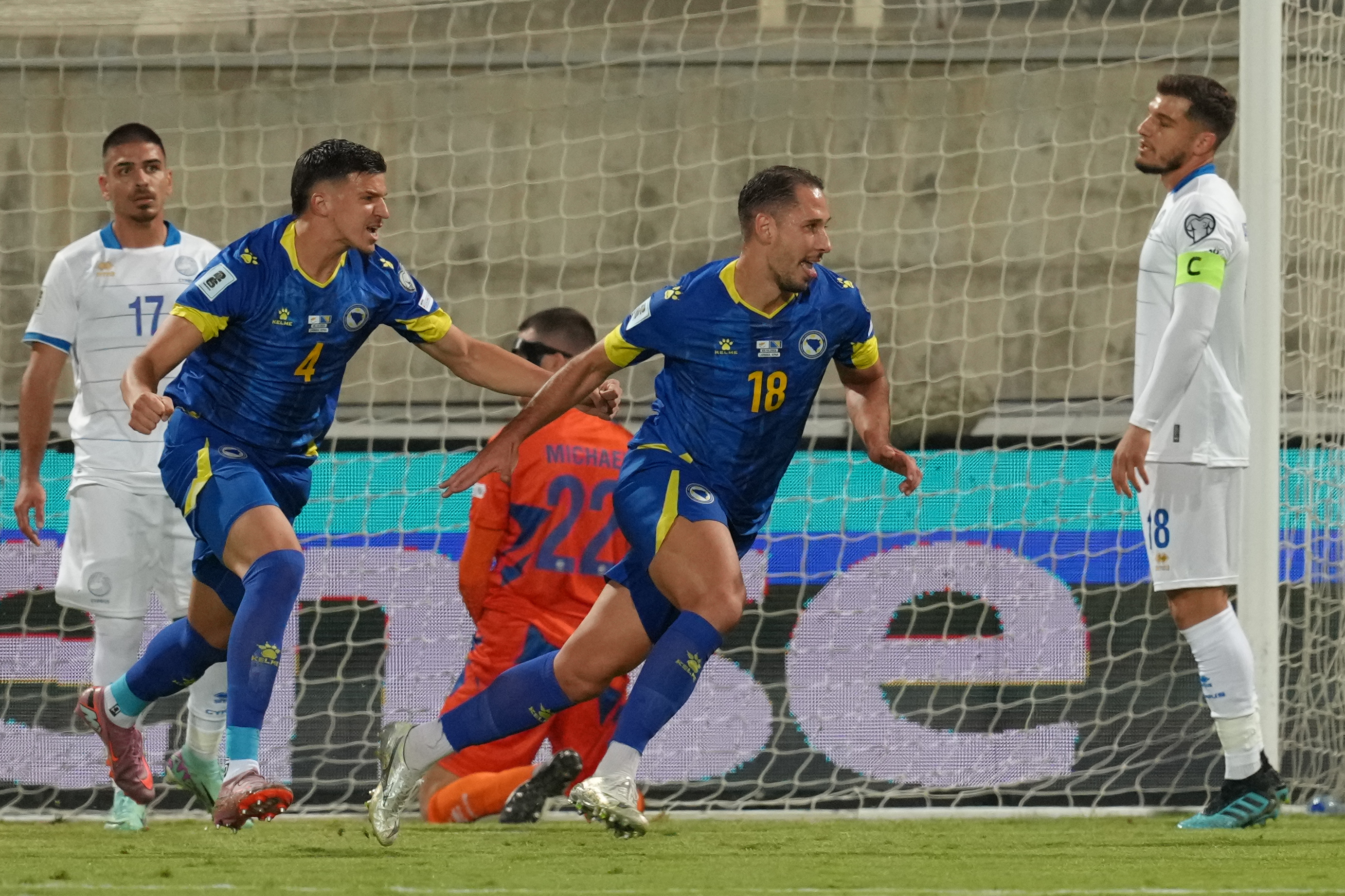 Bosnia-Herzegovina's Tarik Muharemović, left, and Nikola Katic celebrate after a goalduring a World Cup 2026 group H qualifying soccer match between Cyprus and Bosnia-Herzegovina at AEK Arena in Larnaca, Cyprus, on Thursday, Oct. 9, 2025. (AP Photo/Petros