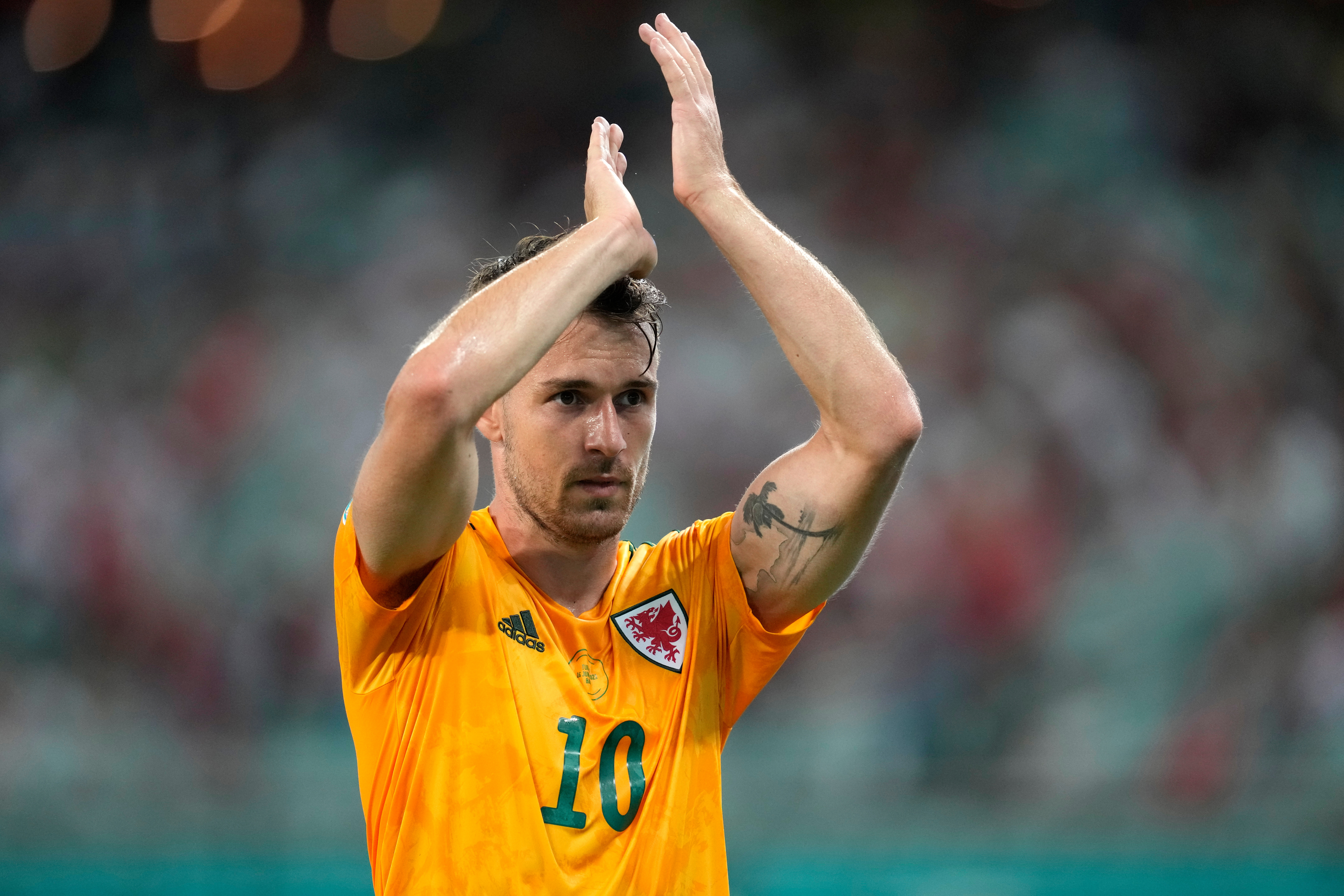 FILE - Wales' Aaron Ramsey addresses spectators during the Euro 2020 soccer championship group A match between Turkey and Wales in Baku, Azerbaijan, on June 16, 2021. (AP Photo/Darko Vojinovic, Pool, File)