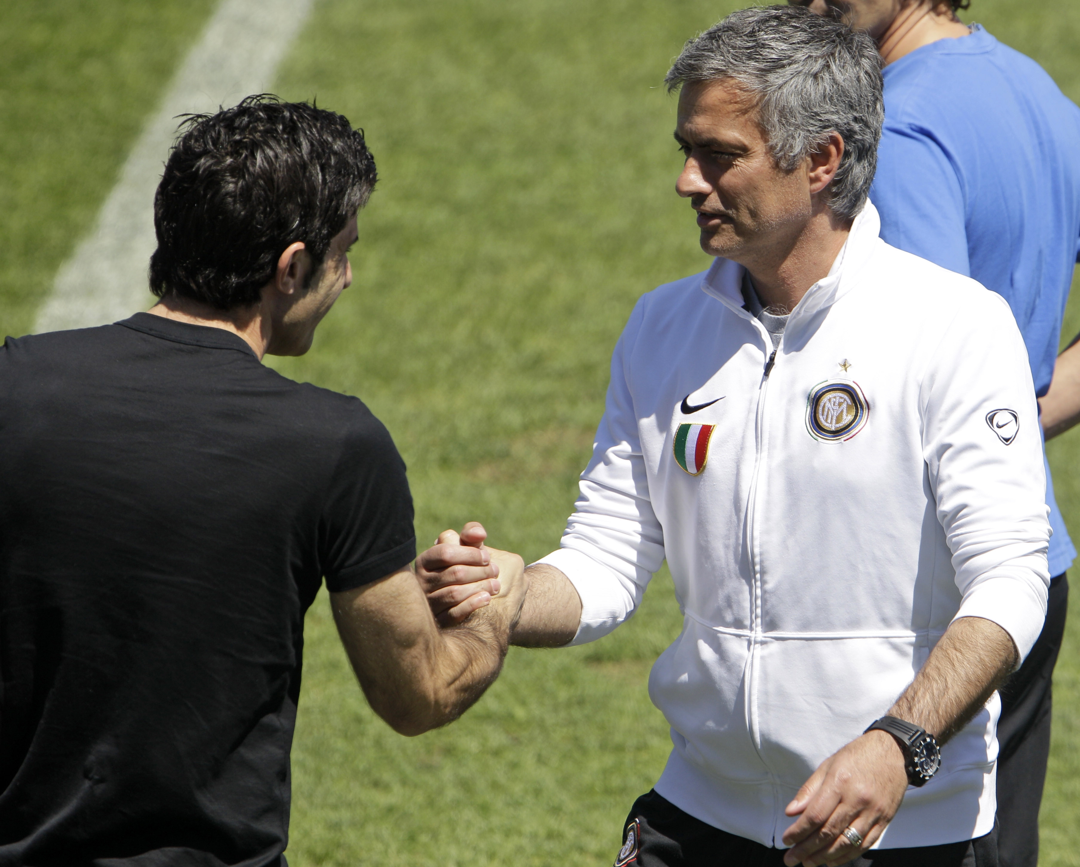 Inter Milan coach Jose Mourinho, right greets Portugese soccer player Luis Figo, left during a training session at the Valdebebas training ground in Madrid, Friday, May 21, 2010. Inter Milan will face Bayern in the Champions League final soccer match at t