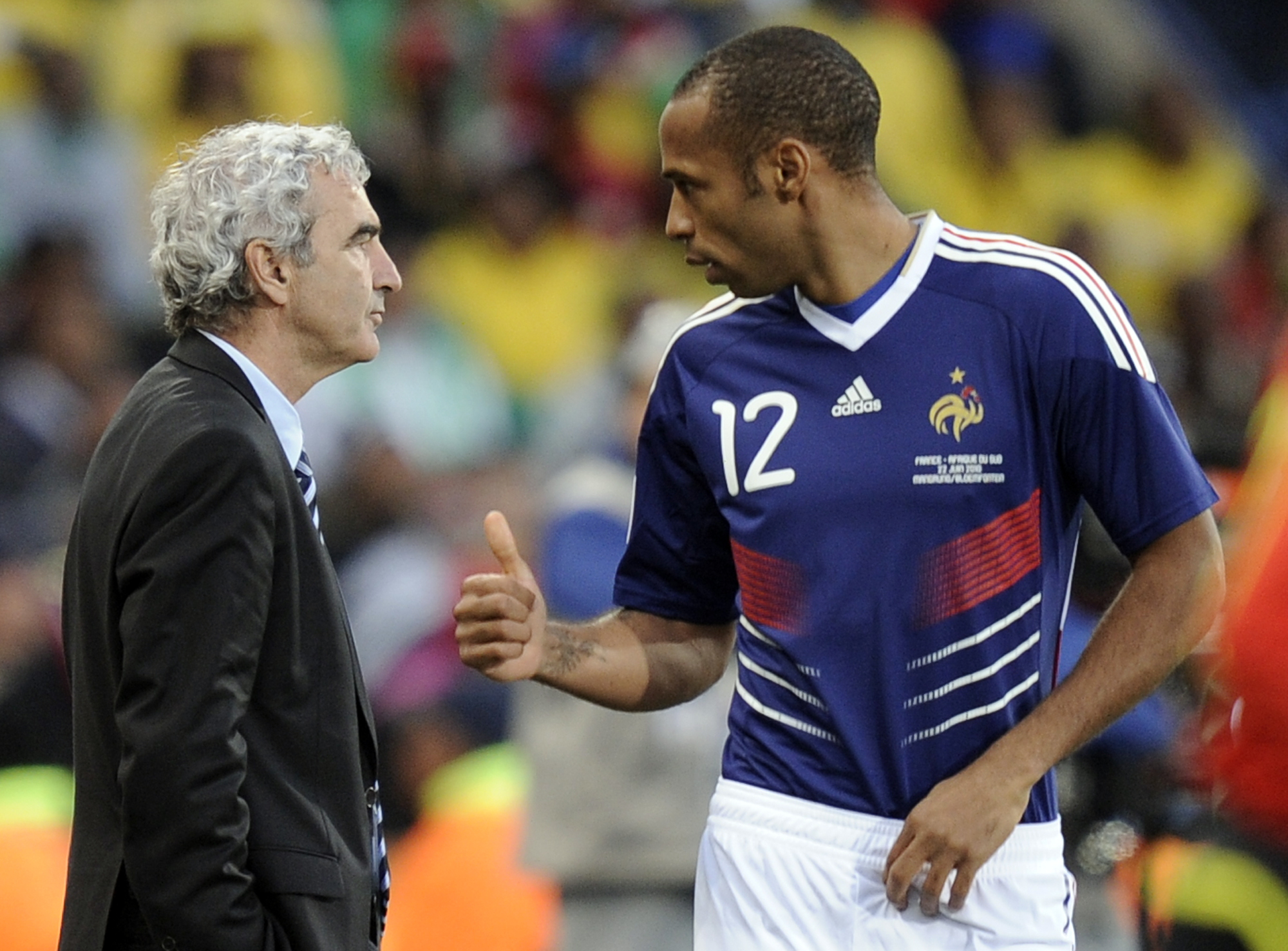 FILE - This June 22, 2010, file photo shows France's Thierry Henry, right,  gesturing as France head coach Raymond Domenech left, watches the World Cup group A soccer match between France and South Africa at Free State Stadium in Bloemfontein, South Afric