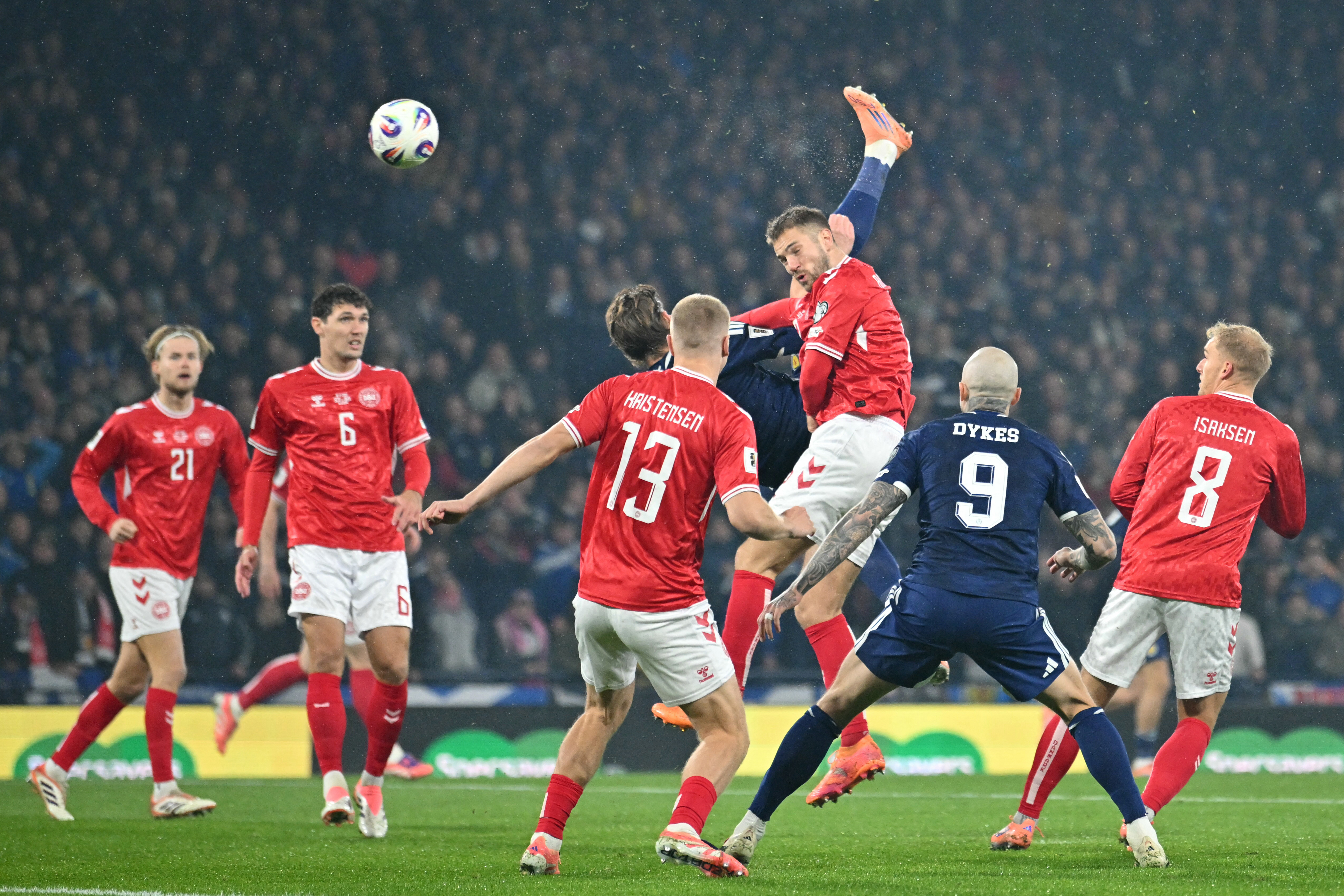 Scotland's midfielder #04 Scott McTominay scores the opening goal with this overhead