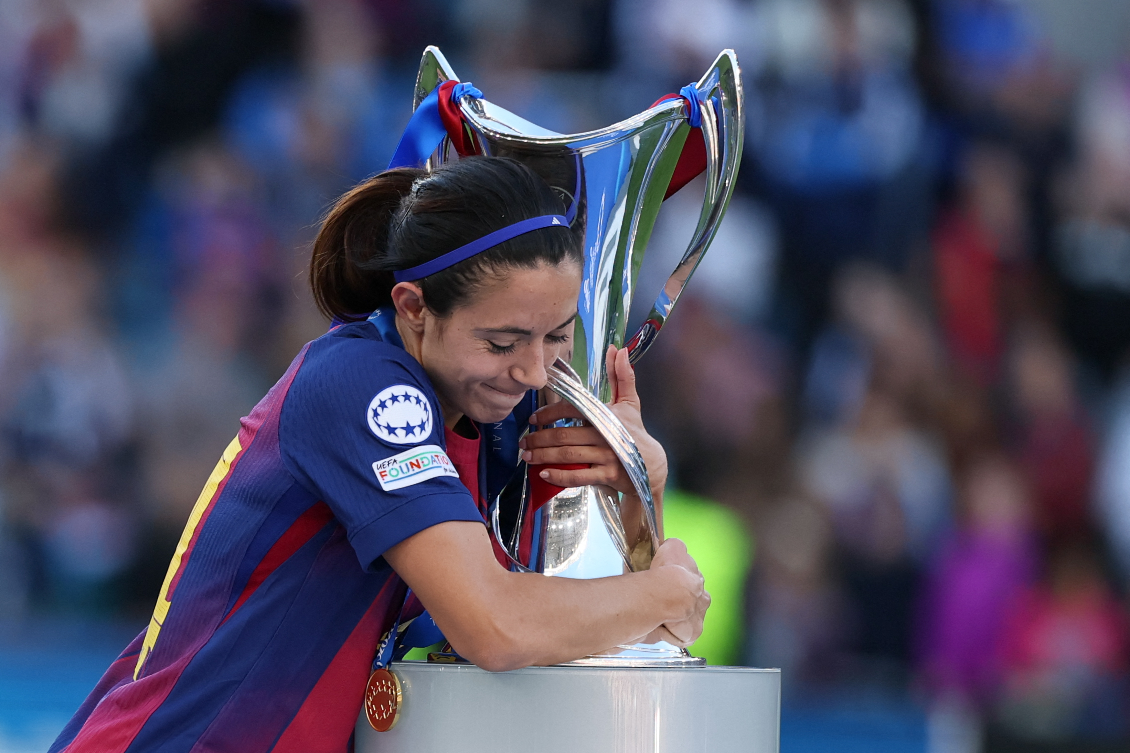 Barcelona's Spanish midfielder #14 Aitana Bonmati hugs the Women's Champions Le