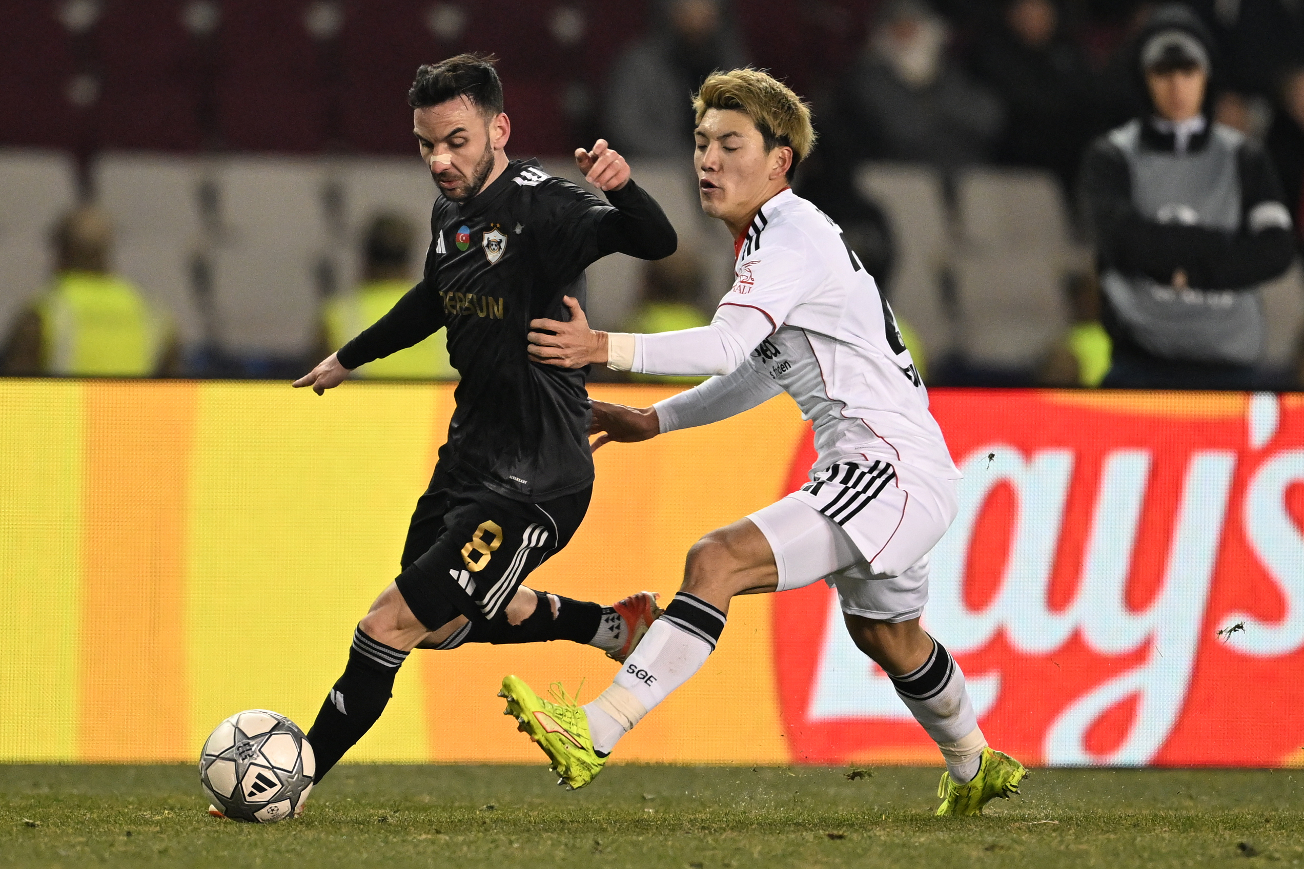 Qarabag's Marko Jankovic, left, and Frankfurt's Ritsu Doan chase the ball during the Champions League opening phase soccer match between Qarabag and Eintracht Frankfurt in Baku, Azerbaijan, Wednesday, Jan. 21, 2026. (AP Photo)