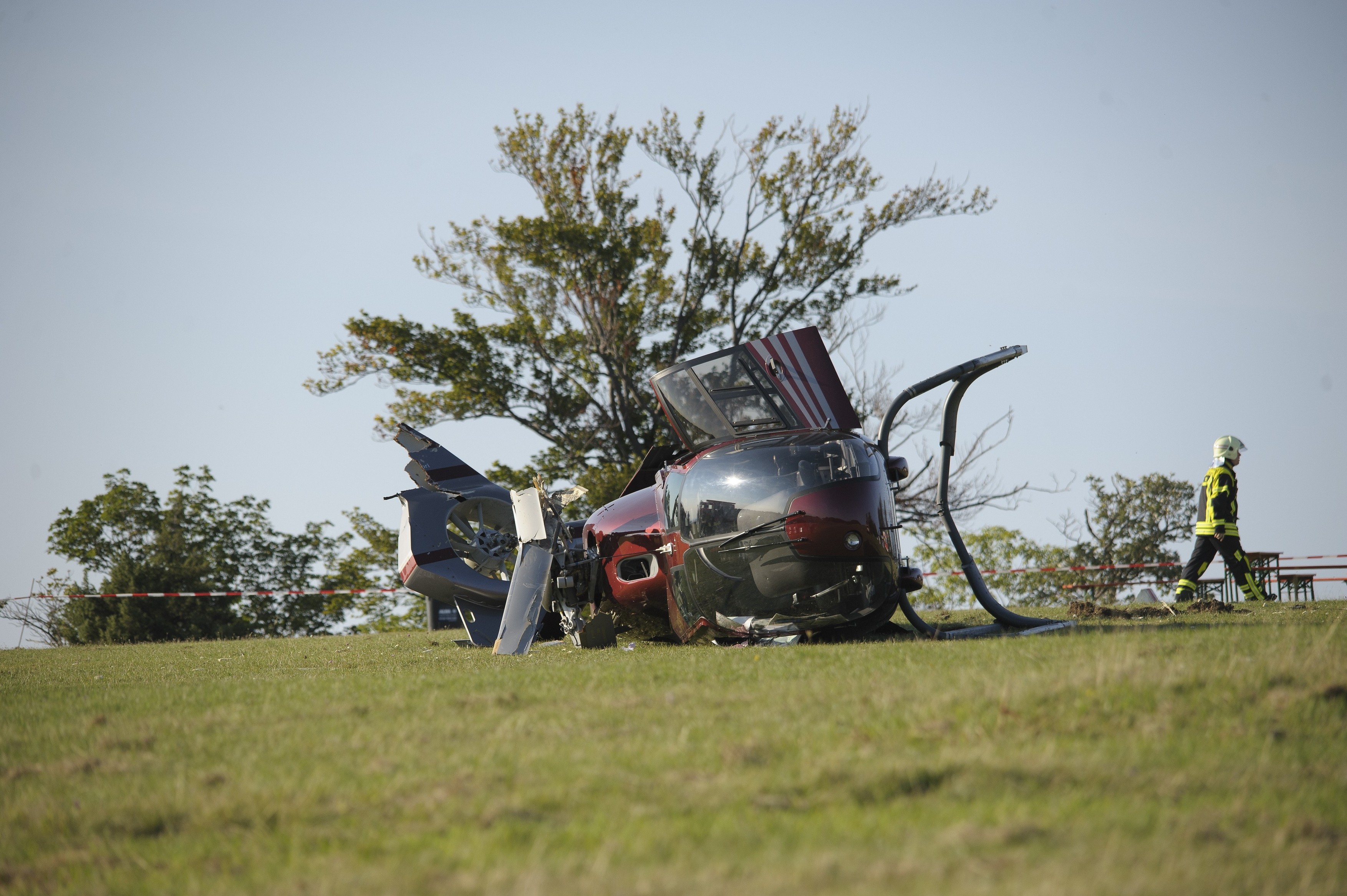 A crashed EC 120 helicopter, an ambulance standing at the back