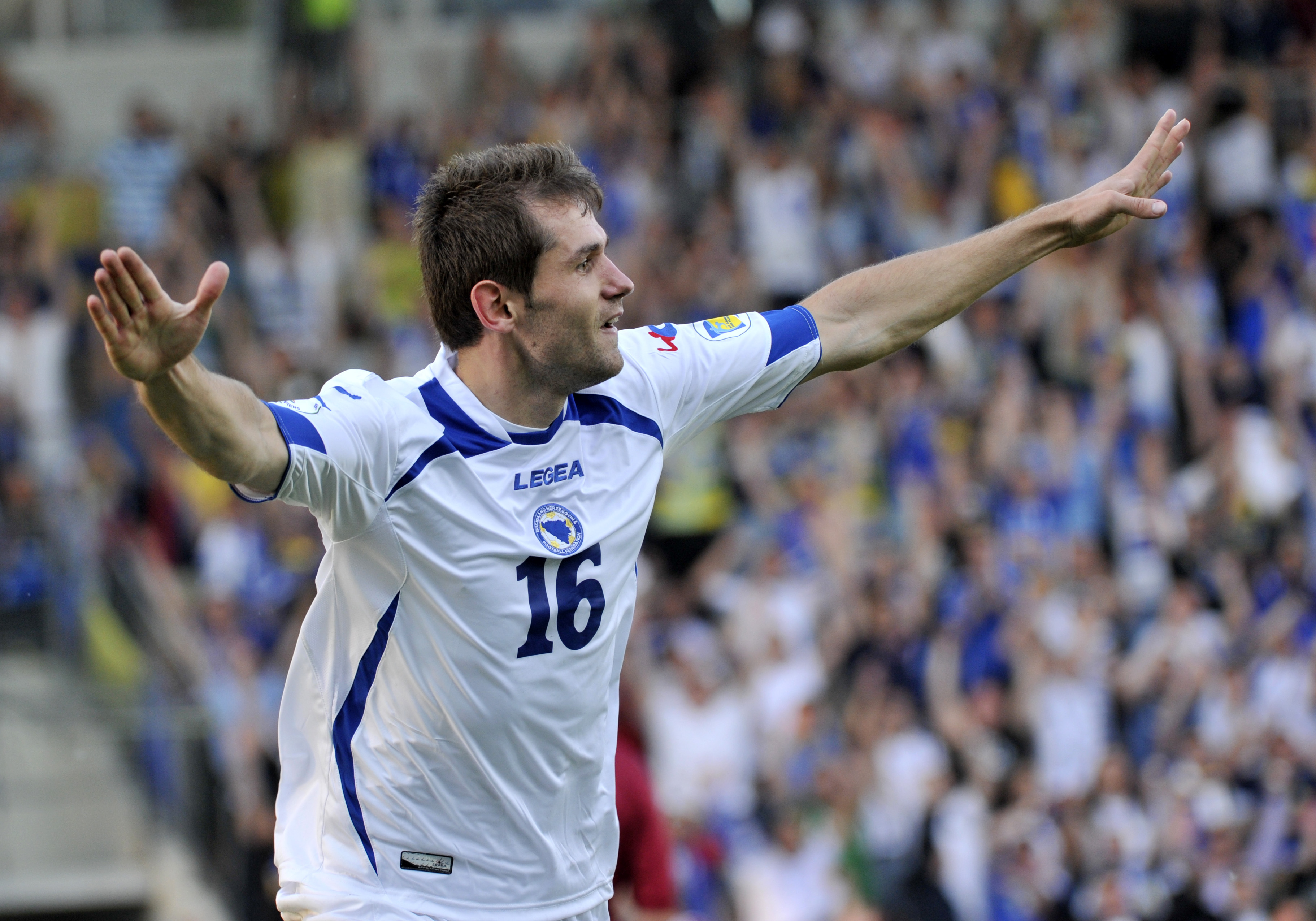 Bosnia's Senad Lulic celebrates after scoring a goal against Latvia during their World Cup 2014 Group G qualification match in Riga, Latvia, on Friday, June 7, 2013. (AP Photo/Roman Koksarov)