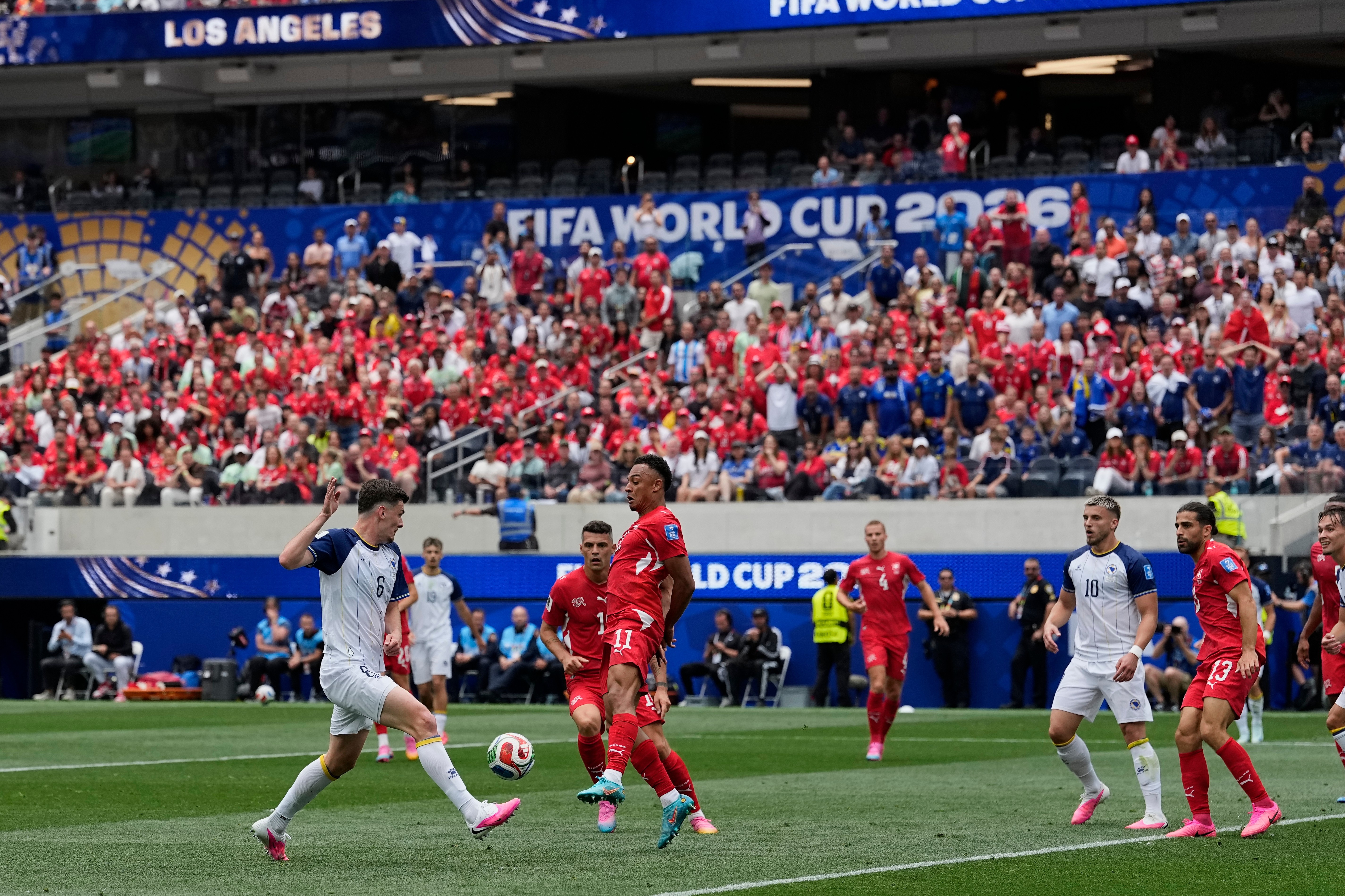 Bosnia's Benjamin Tahirovic (6) left, challenges for the ball with Switzerland's Dan Ndoye (11) during the World Cup Group B soccer match between Switzerland and Bosnia in Inglewood, Calif, near Los Angeles, Thursday, June 18, 2026. (AP Photo/Gregory Bull