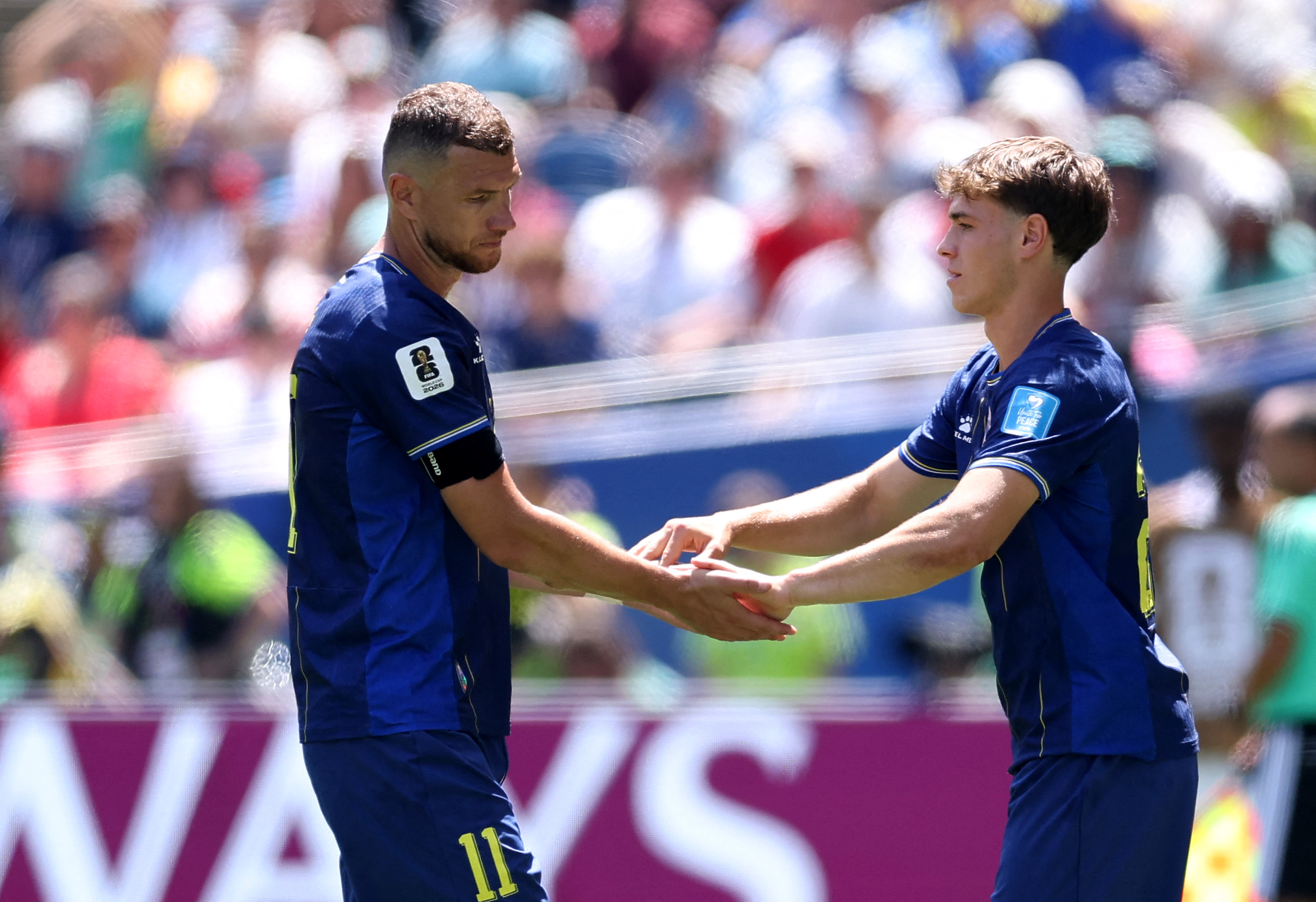 SEATTLE, WASHINGTON - JUNE 24: Edin Dzeko #11 of Bosnia and Herzegovina reacts with Ermin Mahmic #26 as he is substituted during the FIFA World Cup 2026 Group B match between Bosnia and Herzegovina and Qatar at Seattle Stadium on June 24, 2026 in Seattle,