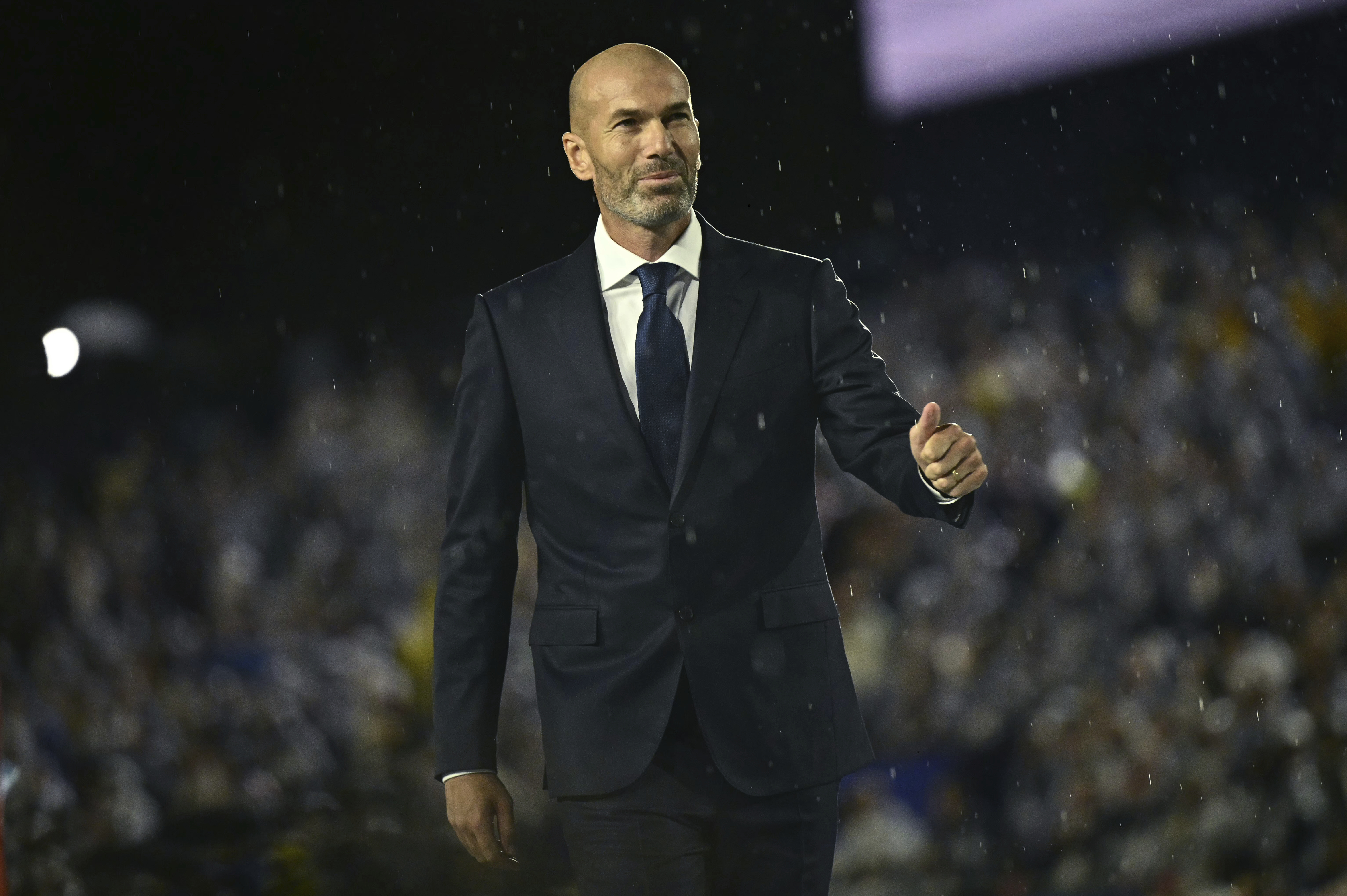 France soccer star Zinedine Zidane arrives on stage at the Trocadero during the opening ceremony for the 2024 Summer Olympics in Paris, France, Friday, July 26, 2024. (Loic Venance/Pool Photo via AP)