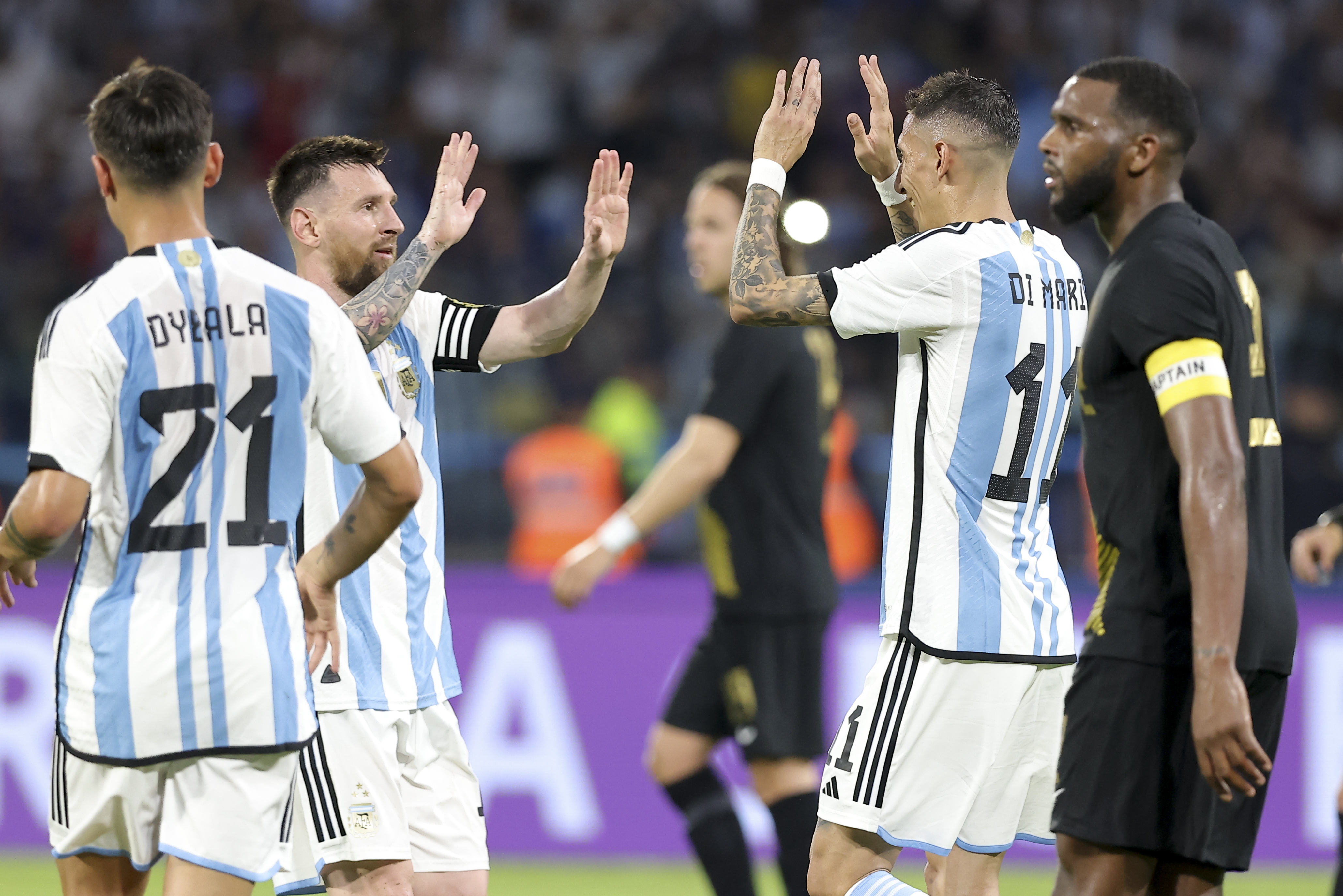 Argentina's Angel Di Maria, right, celebrates scoring his side's 6th goal with teammate Lionel Messi during an international friendly soccer match against Curacao in Santiago del Estero, Argentina, Tuesday, March 28, 2023. (AP Photo/Nicolas Aguilera)