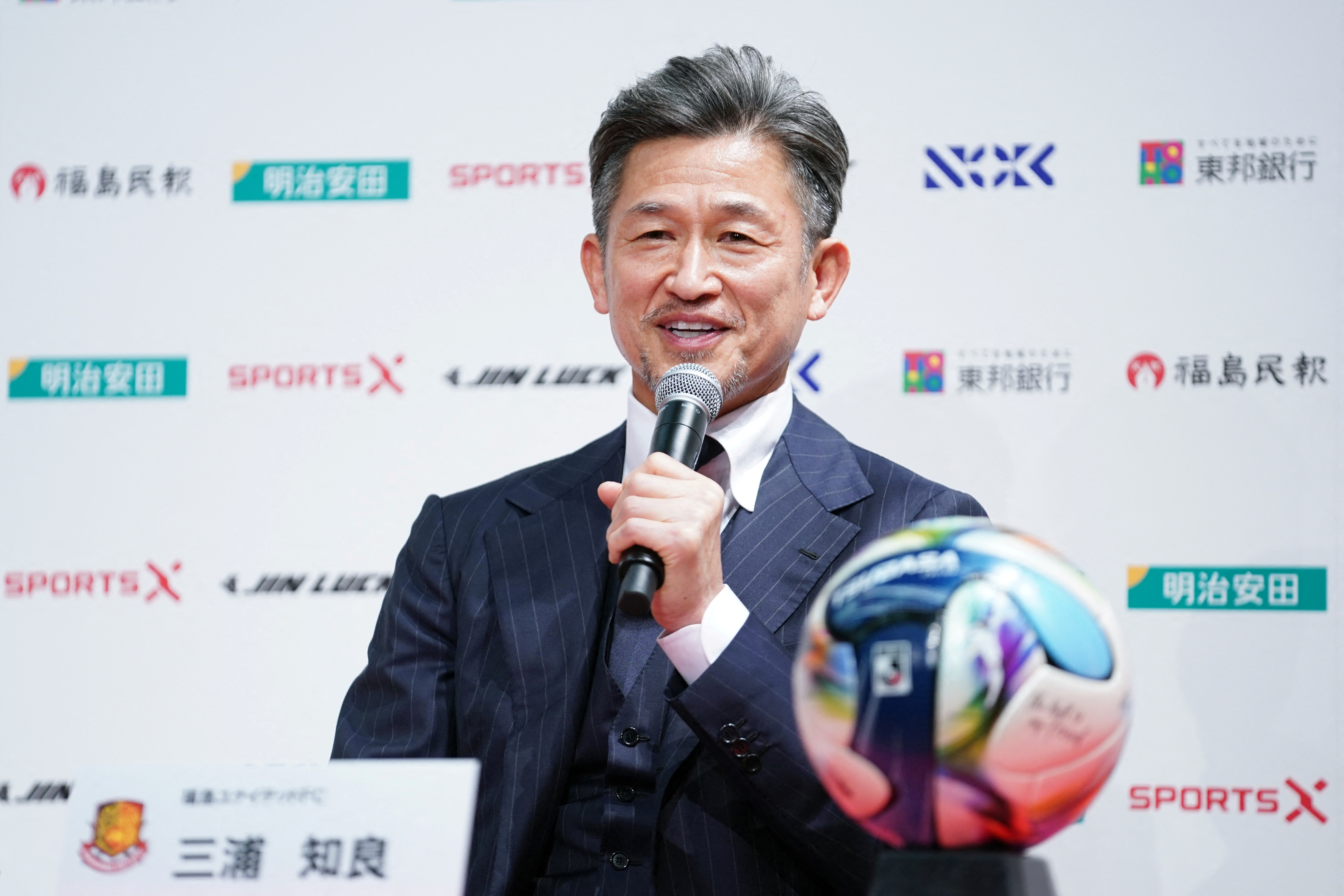 Japanese footballer Kazuyoshi Miura, 58, speaks during a press conference to annou