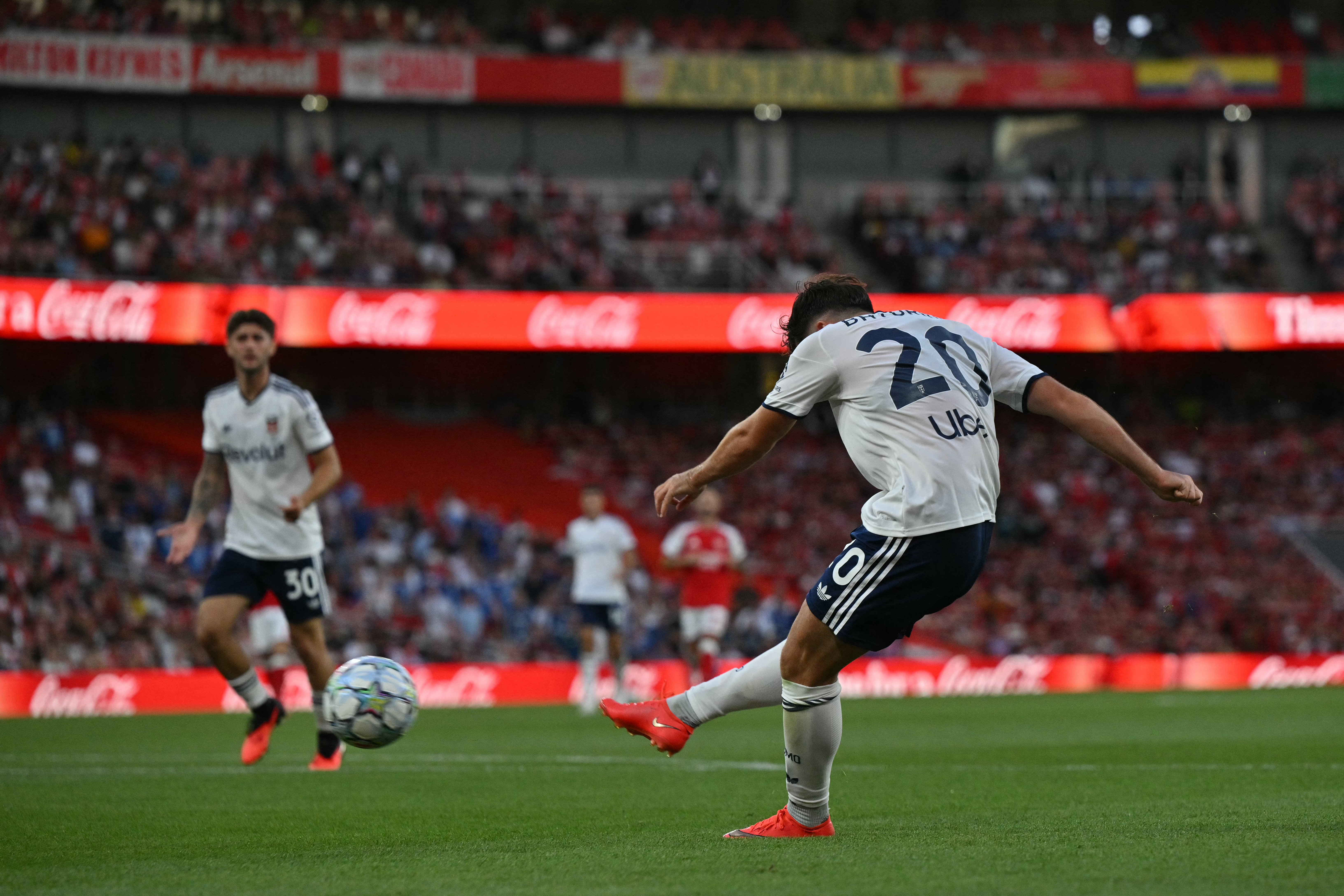 Como's Croatian midfielder #20 Martin Baturina scores the team's first goal during the pre season football match between Arsenal and Como 1907 at the Emirates Stadium in London on August 8, 2026. (Photo by Glyn KIRK / AFP) / RESTRICTED TO EDITORIAL USE. N