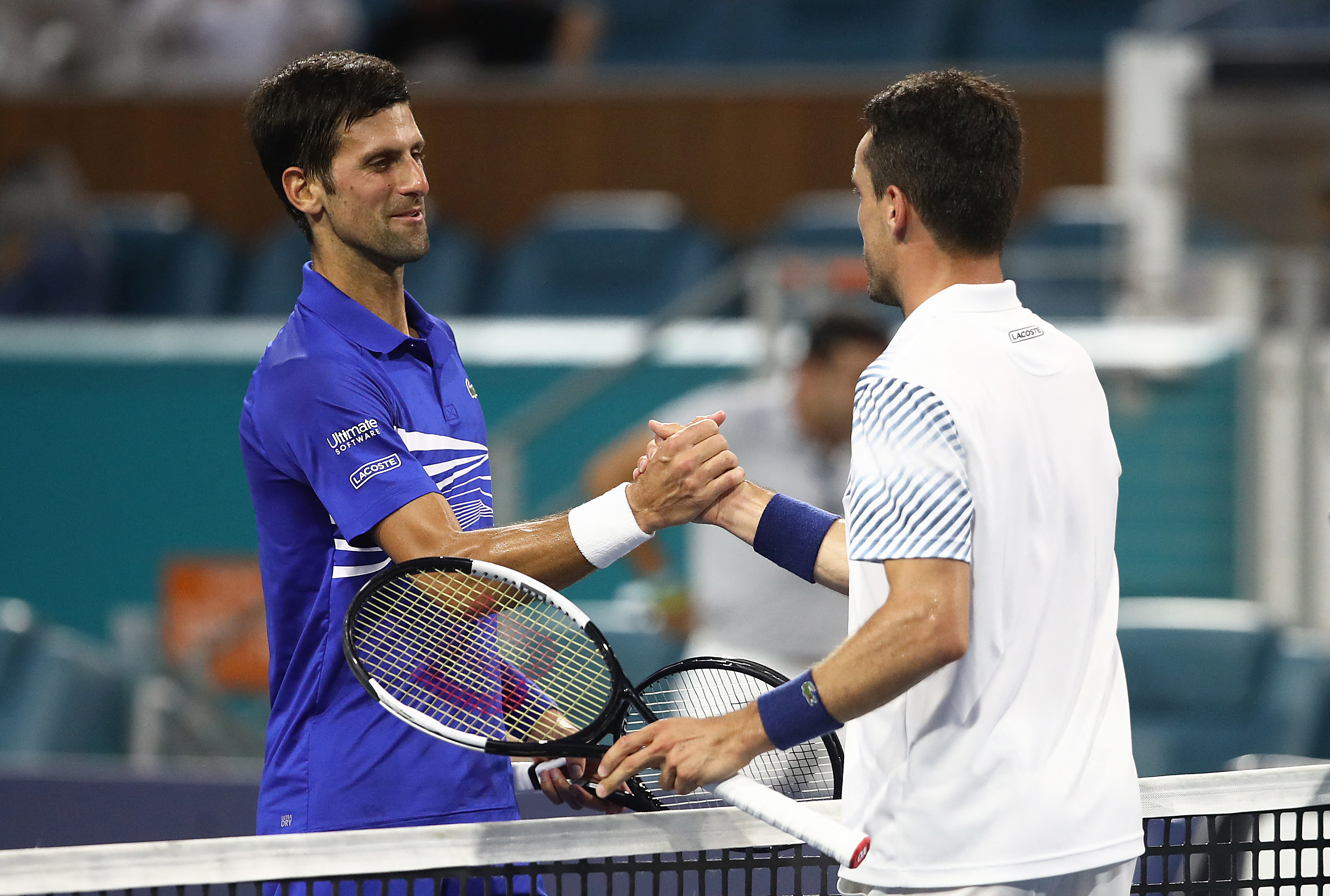 MIAMI GARDENS, FLORIDA - MARCH 26: Roberto Bautista Agut of Spain is congratulated