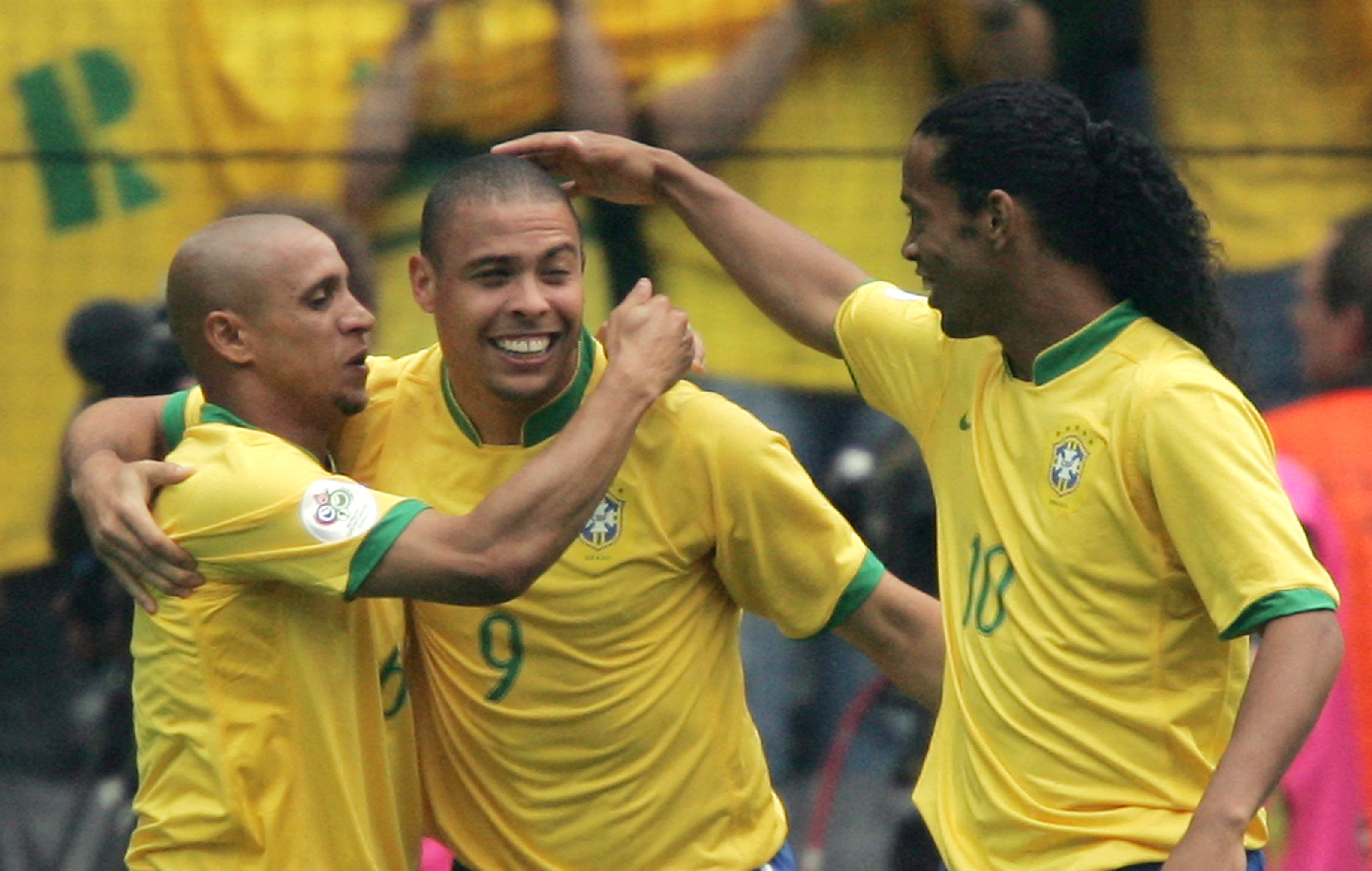 Brazilian forward Ronaldo (C) celebrates with Brazilian defender Roberto Carlos (L) and Brazilian midfielder Ronaldinho (R) after scoring his team's first goal during the round of 16 World Cup football match between Brazil and Ghana at Dortmund's World Cu