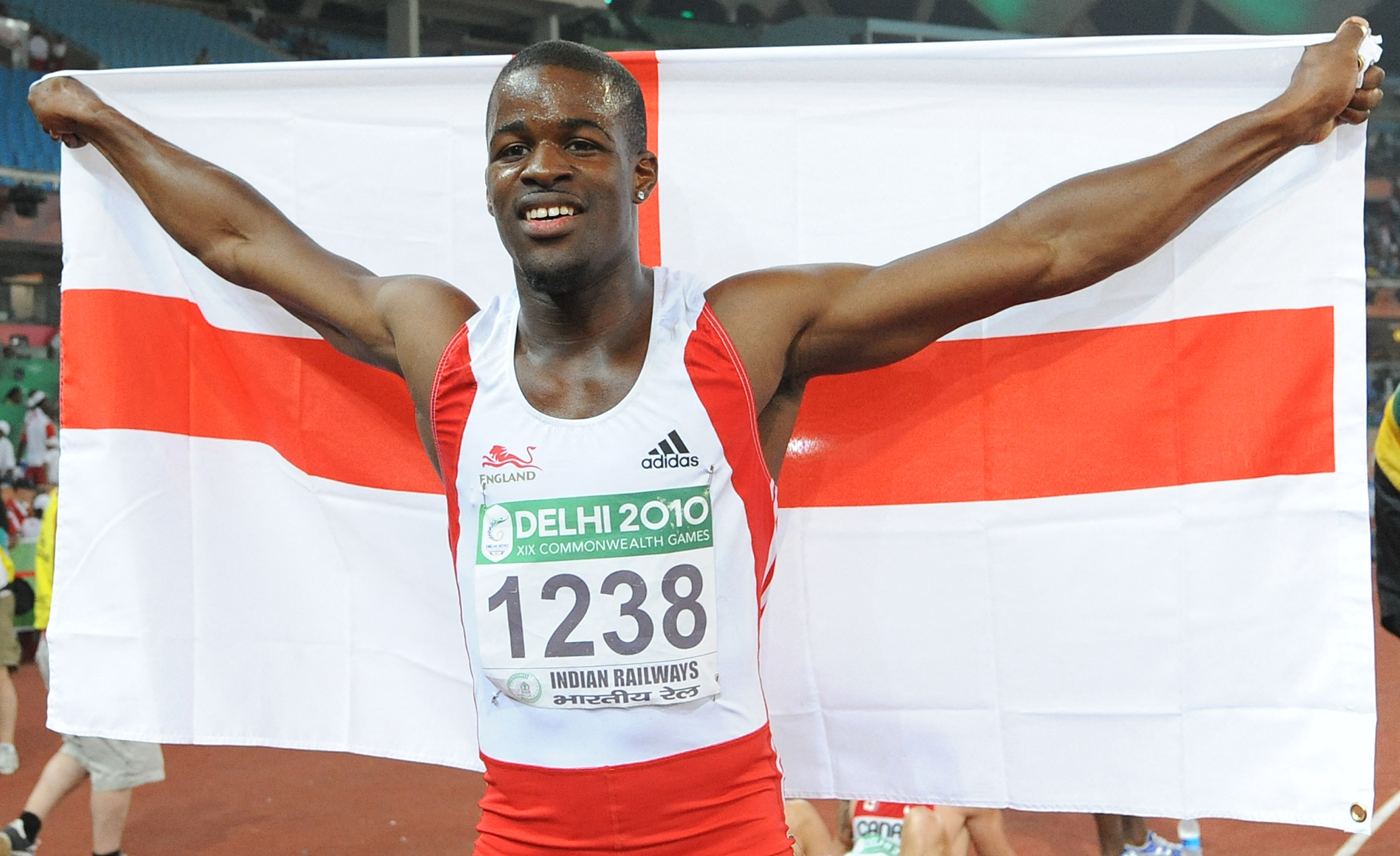England's Leon Baptiste celebrates his win in the 200m final of the Track and Field competition of the XIX