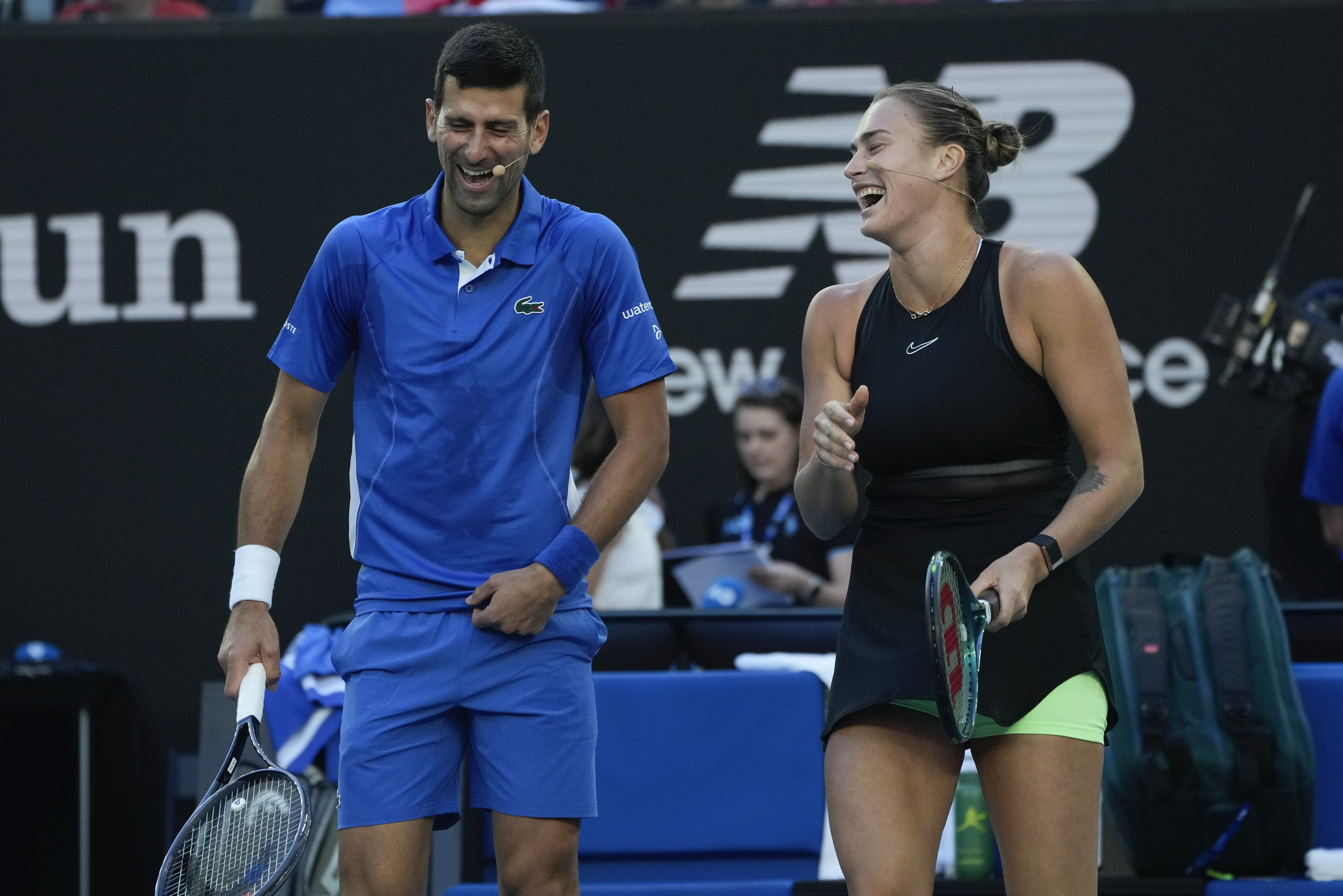 Serbia's Novak Djokovic and Aryna Sabalenka of Belarus react during an exhibition match against Stefanos Tsitsipas of Greece and compatriot Maria Sakkari ahead of the Australian Open tennis championships at Melbourne Park, Melbourne, Australia, Thursday,
