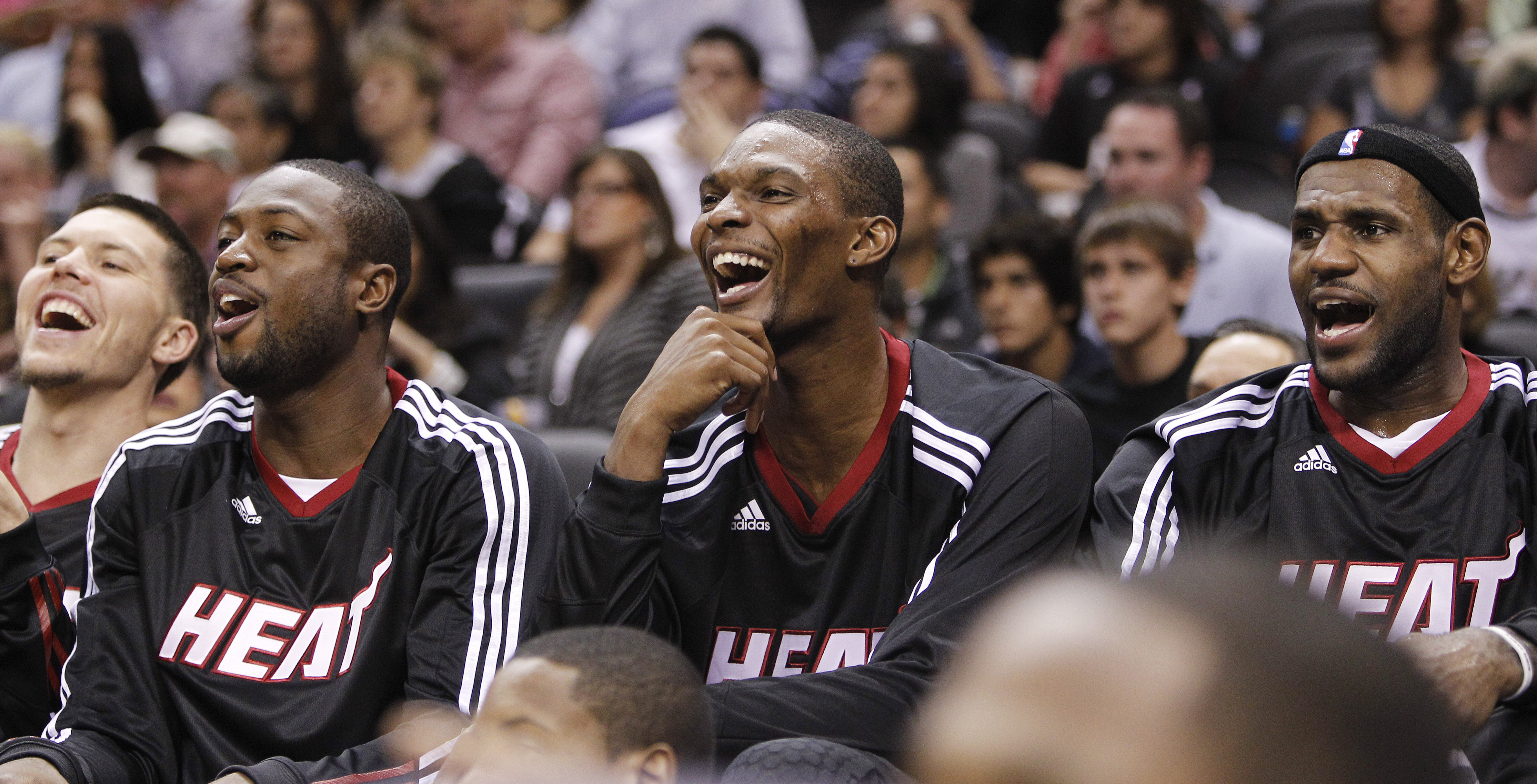 Miami Heat's Dwyane Wade, left, Chris Bosh, center, and LeBron James react on the bench during the second quarter of an NBA preseason basketball game against the San Antonio Spurs, Saturday, Oct. 9, 2010 in San Antonio. (AP Photo/Eric Gay)