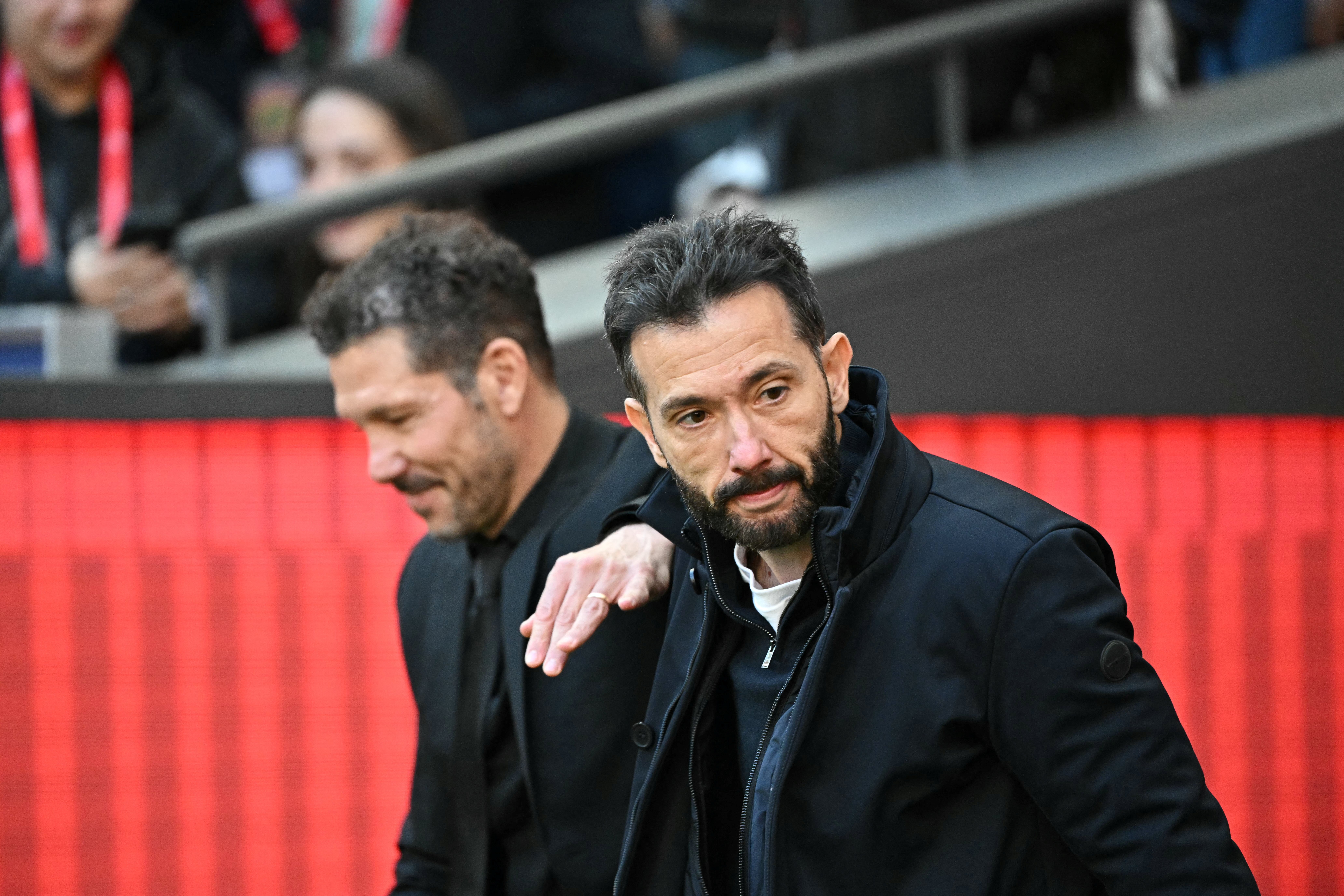 Atletico Madrid's Argentine coach Diego Simeone and Valencia's Spanish coach # 00 Carlos Corberan meet prior the Spanish league football match between Club Atletico de Madrid and Valencia CF at Metropolitano Stadium in Madrid on December 13, 2025. (Photo