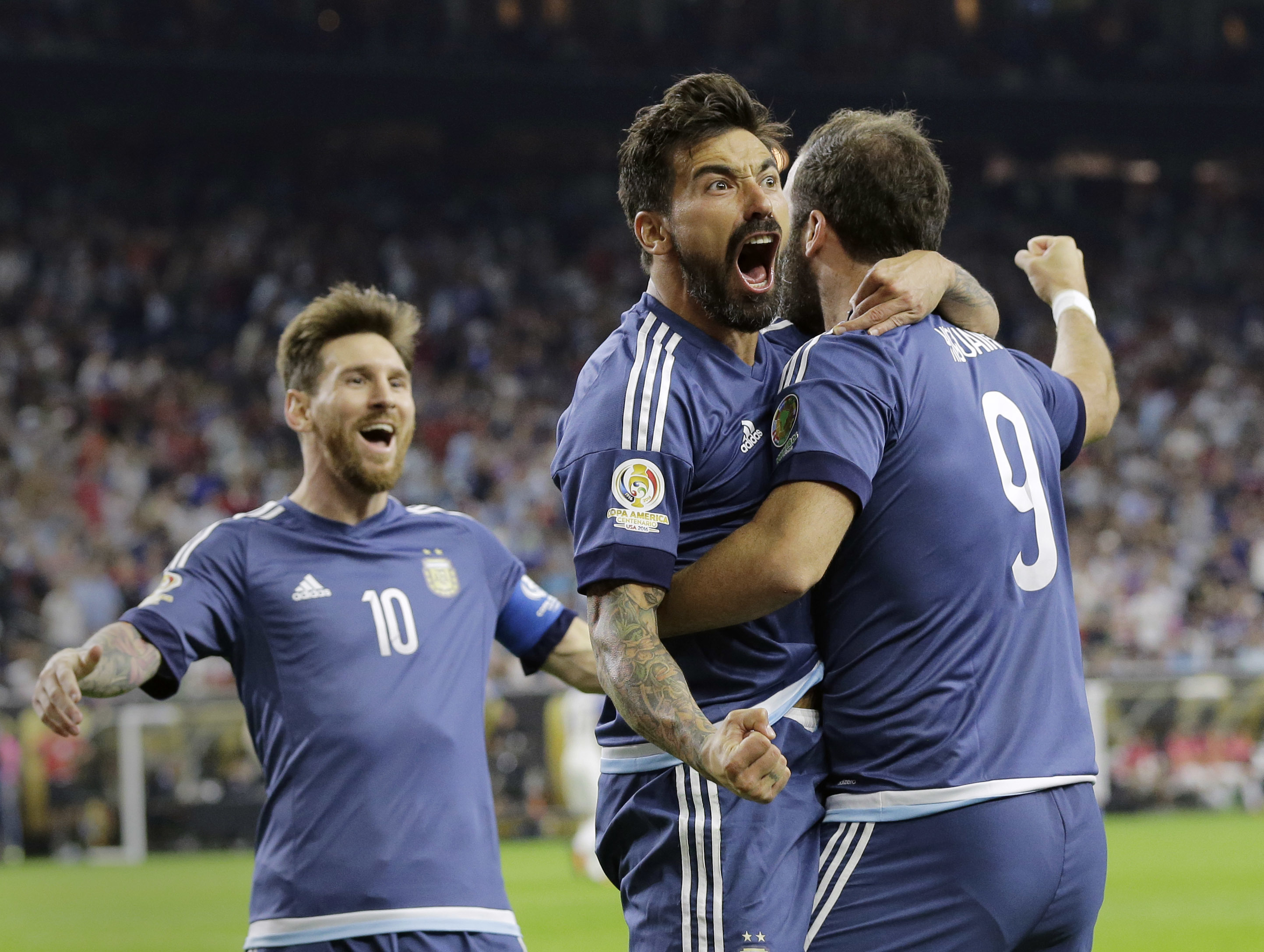 Argentina's Gonzalo Higuain (9) celebrates his goal against the United States with Lionel Messi, left, and Ezequiel Lavezzi, center, during a Copa America Centenario soccer semifinal, Tuesday, June 21, 2016, in Houston. Argentina won 4-0. (AP Photo/Eric G