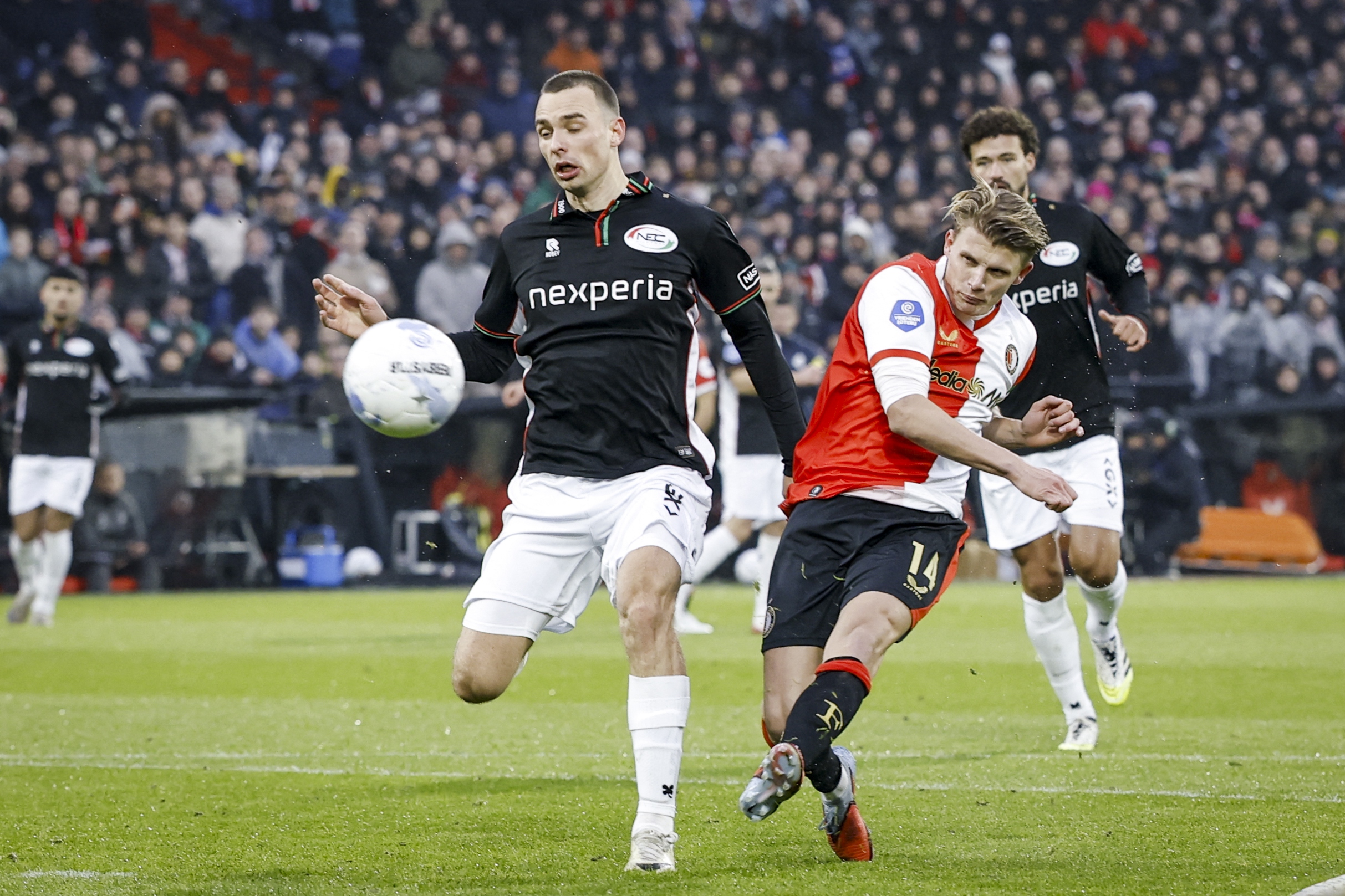 Darko Nejasmic of NEC Nijmegen (L) fights for the ball with Sem Steijn of Feyenoord