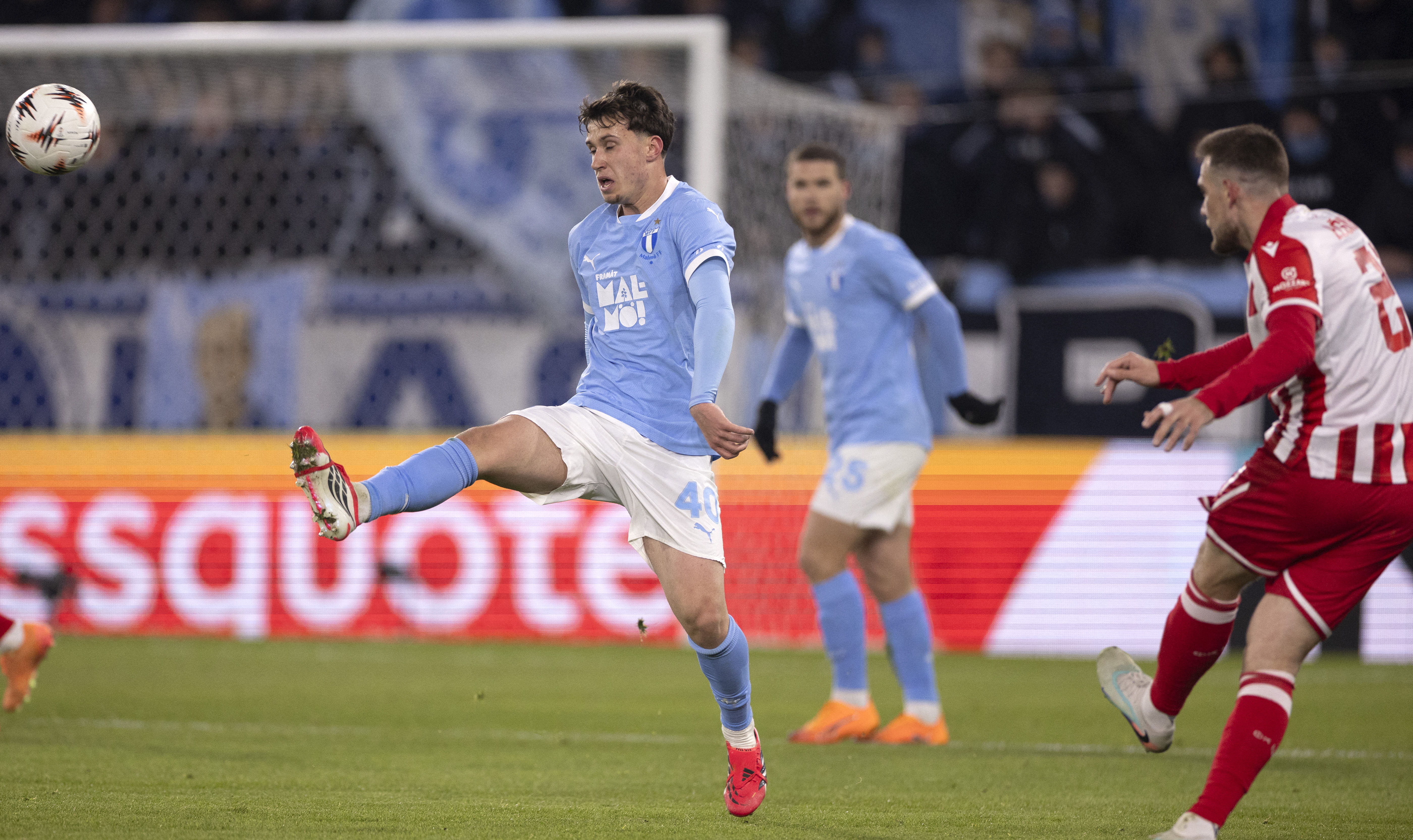 Malmo FF's Swedish midfielder #40 Kenan Busuladzic reaches for the ball the