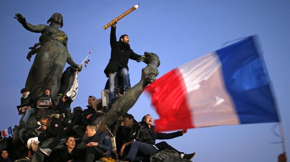 a-man-holds-a-giant-pencil-as-he-takes-part-in-a-solidarity-march-in-paris-on-january-11-2015-the-march-follows-the-horrific-attacks-by-50923.jpeg