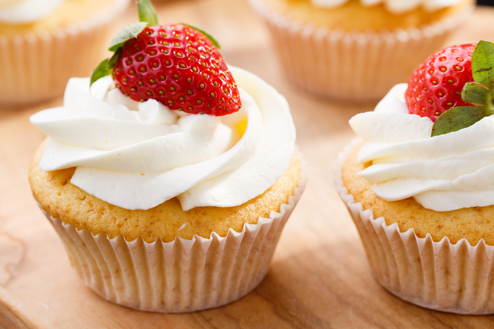 Strawberry,Capcake,In,A,Cardboard,Box,On,An,Olive,Board